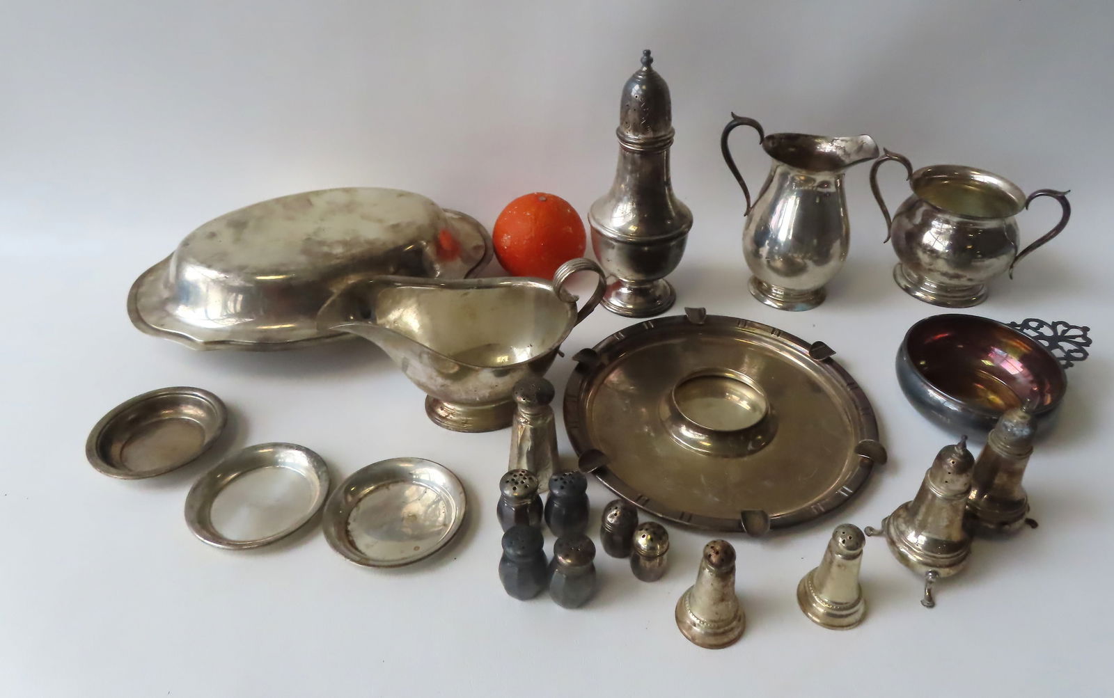 A large grouping of sterling silver including Gorham gravy boat, BH sugar and creamer, Gorham: A large grouping of sterling silver including Gorham gravy boat, BH sugar and creamer, Gorham warming dish - this is the largest piece measuring 11 1/2"L x 7 5/8"W, an unusual B & H ashtray with peopl