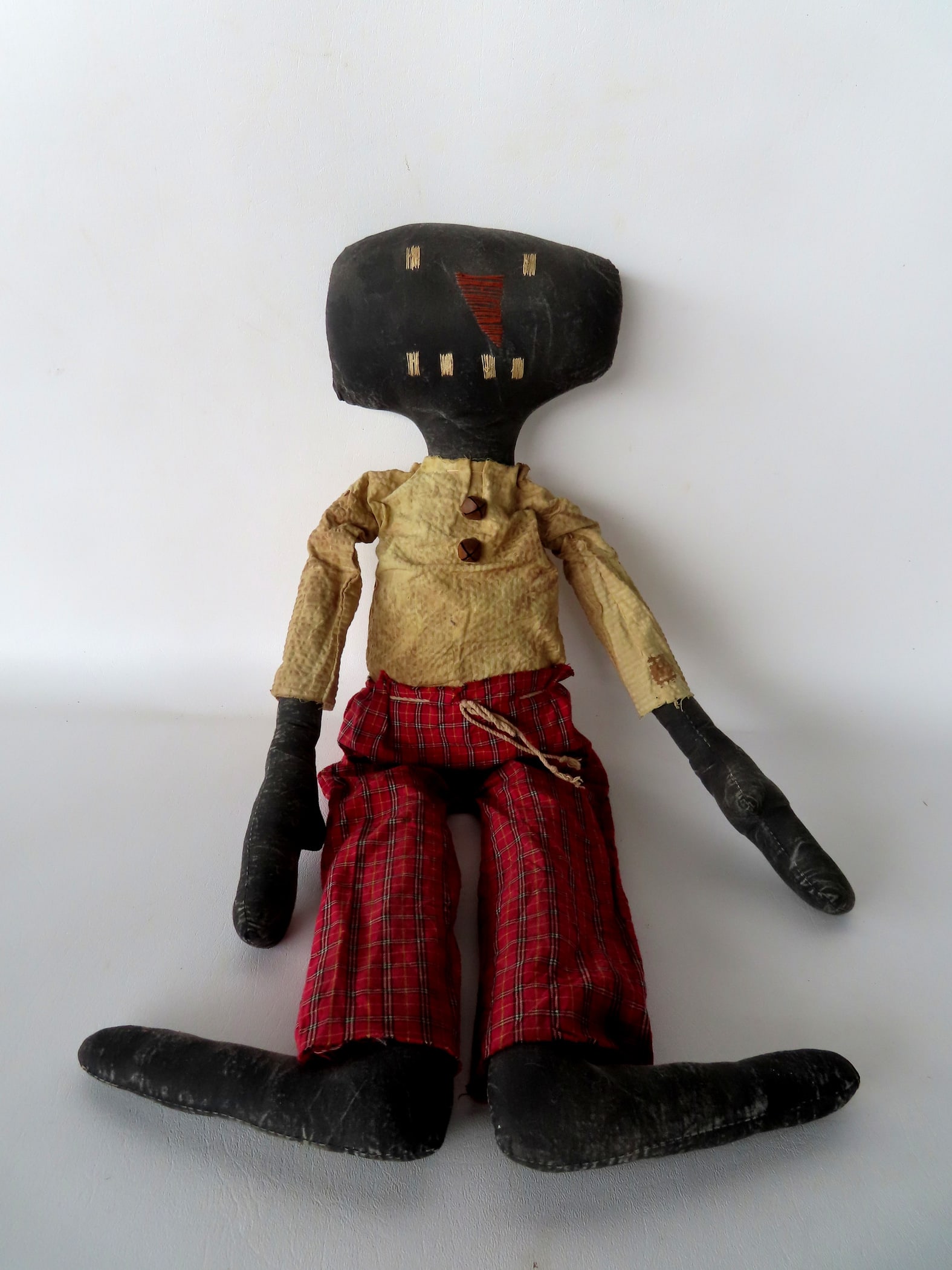 A folk art hand made Black doll with embroidered facial features and original costume, probably: A folk art hand made Black doll with embroidered facial features and original costume, probably early to mid 20th century. Good condition. 25"L.