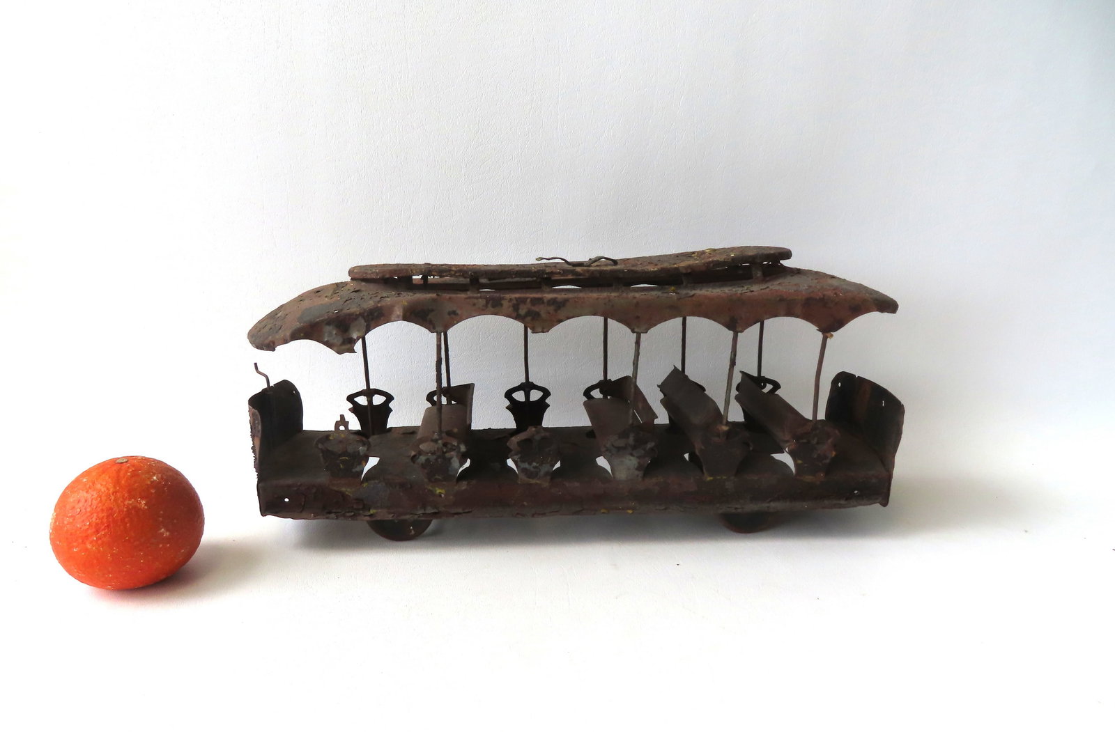 A large tin open air trolley car in poor condition needing restoration, late 19th to early 20th: A large tin open air trolley car in poor condition needing restoration, late 19th to early 20th century - missing 2 seats and 2 side posts and most paint is lost and pealing - measures 16 3/8"L x 5"W 
