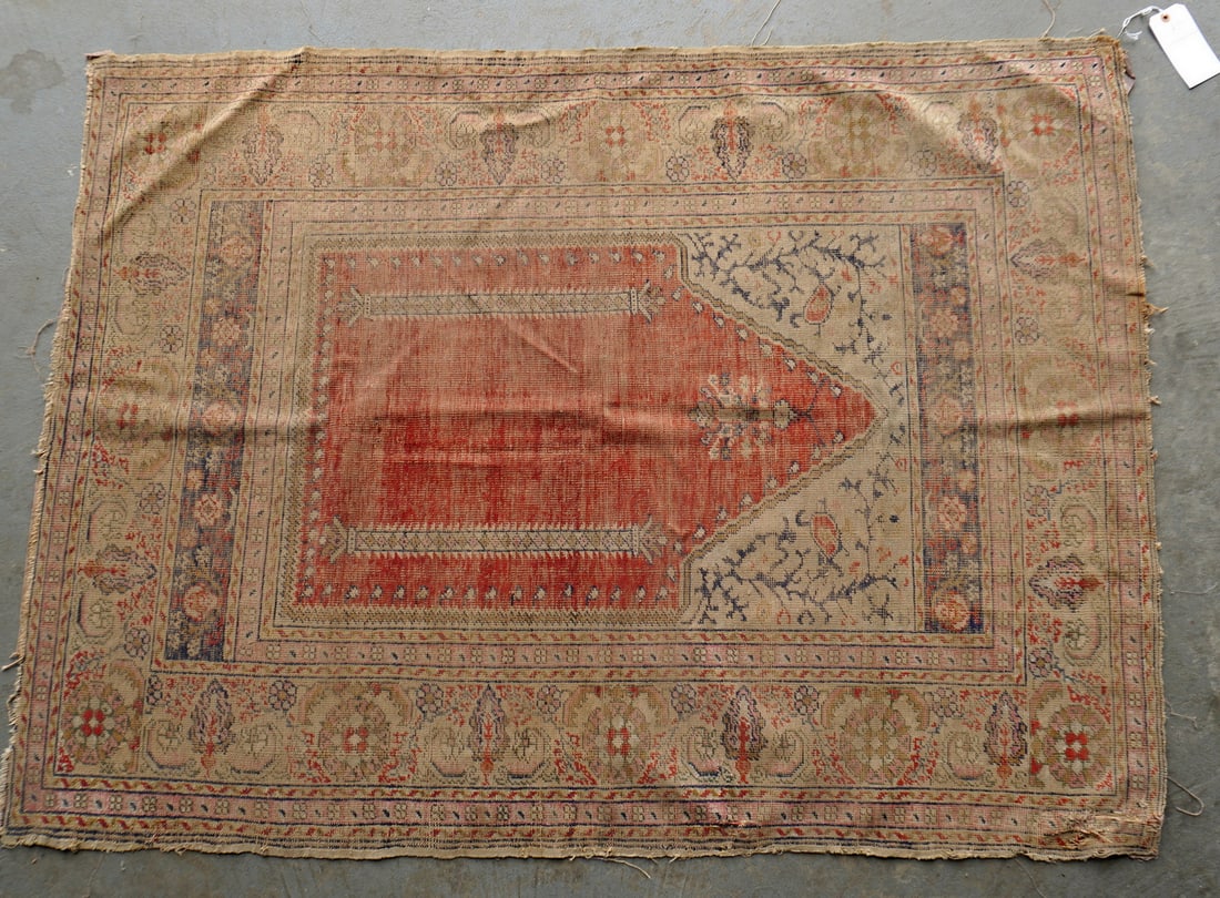 A heavily worn 19th century oriental prayer rug. Measures 3' 9" x 5'.: A heavily worn 19th century oriental prayer rug. Measures 3' 9" x 5'.
