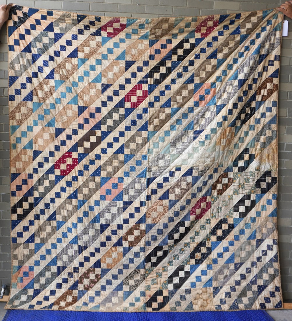 A patchwork quilt, early to mid 20th century. Some staining else good condition. Measures 86" x 93".: A patchwork quilt, early to mid 20th century. Some staining else good condition. Measures 86" x 93".