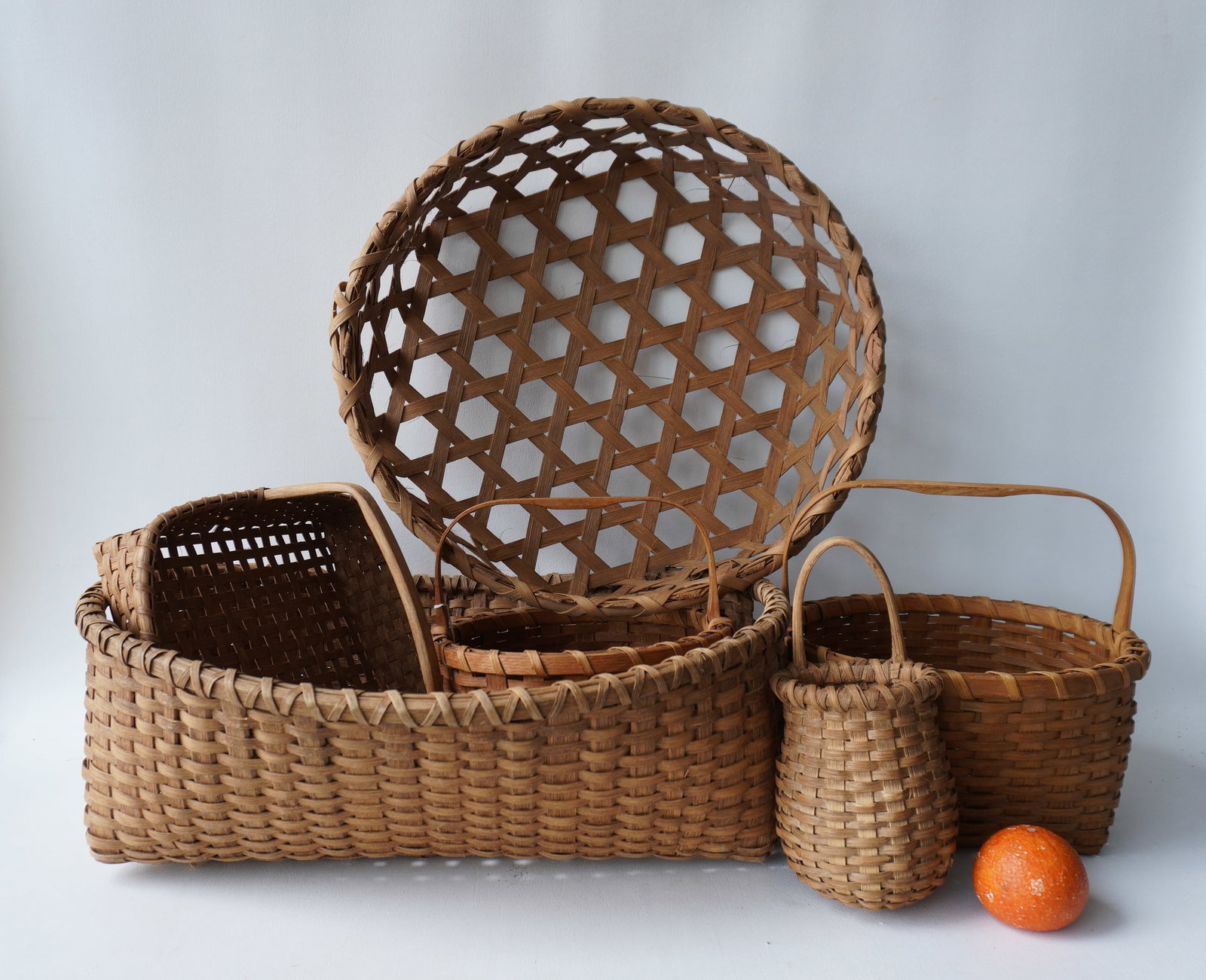 Grouping of 6 hand made splint baskets, circa ealy to mid 1950 - most in very good condition: Grouping of 6 hand made splint baskets, circa ealy to mid 1950 - most in very good condition with no splint breaks or damage. The largest, the cheese basket measures 20" diameter x 7"H. Provenance: Fr