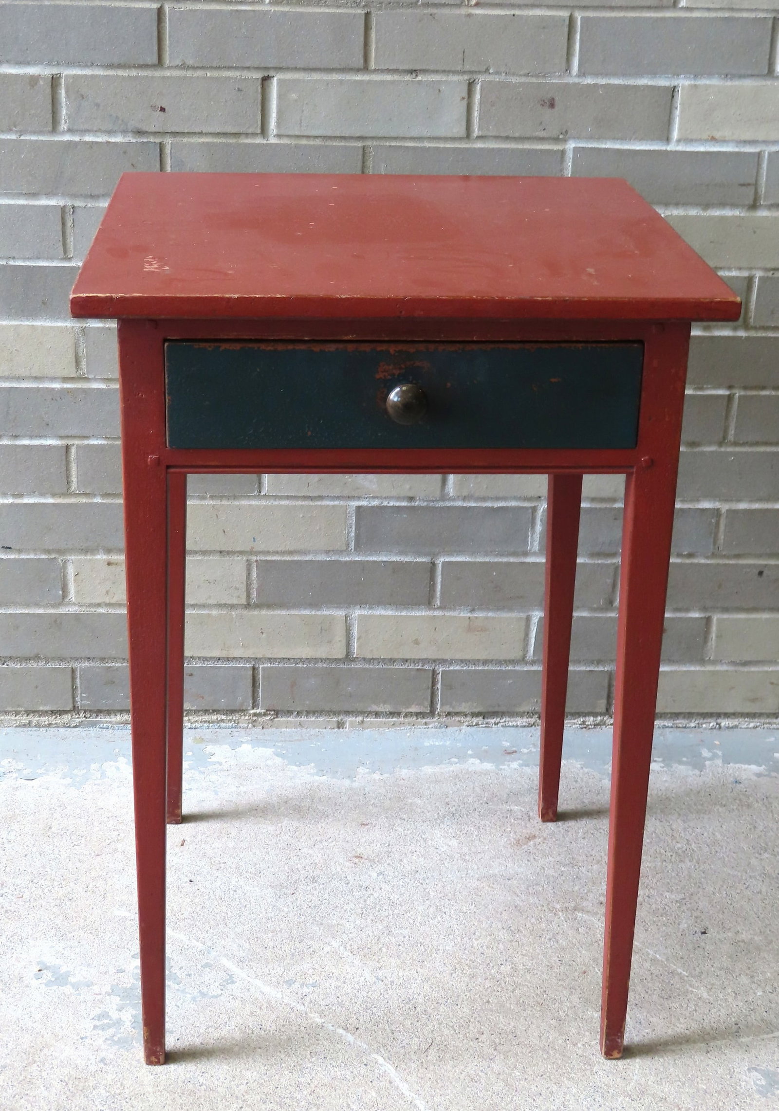A custom made Hepplewhite style 1 drawer stand in red paint: A custom made Hepplewhite style 1 drawer stand in red paint and tapered legs, the drawer in dark blue paint, made by Barton-Sharpe of NY City (paper label applied to drawer interior), late 20th centur