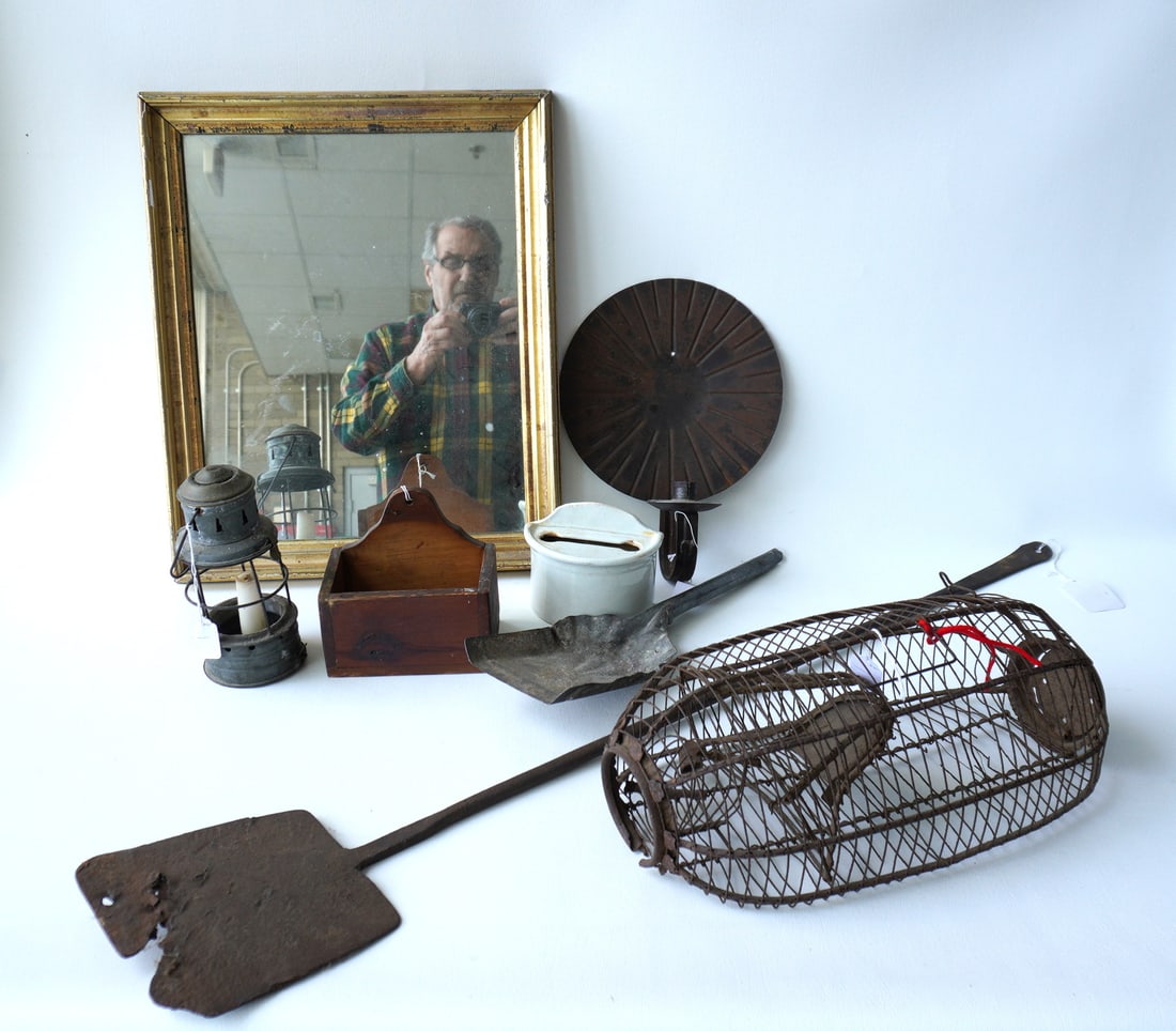A grouping of country collectibles, most 19th century.: A grouping of country collectibles including a hand forged iron peel (some losses at base), lemon gold framed mirror - 19th century, wire rat cage - some losses at base, 20th century wall sconce, tin