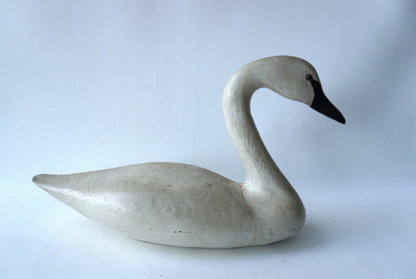 A composition swan decoy with glass eyes signed GC'87. Good condition. Measures 24"L x 13 3/4"H x 9": A composition swan decoy with glass eyes signed GC'87. Good condition. Measures 24"L x 13 3/4"H x 9"W. Provenance: From the Carole Ostergren collection, Wallkill NY.