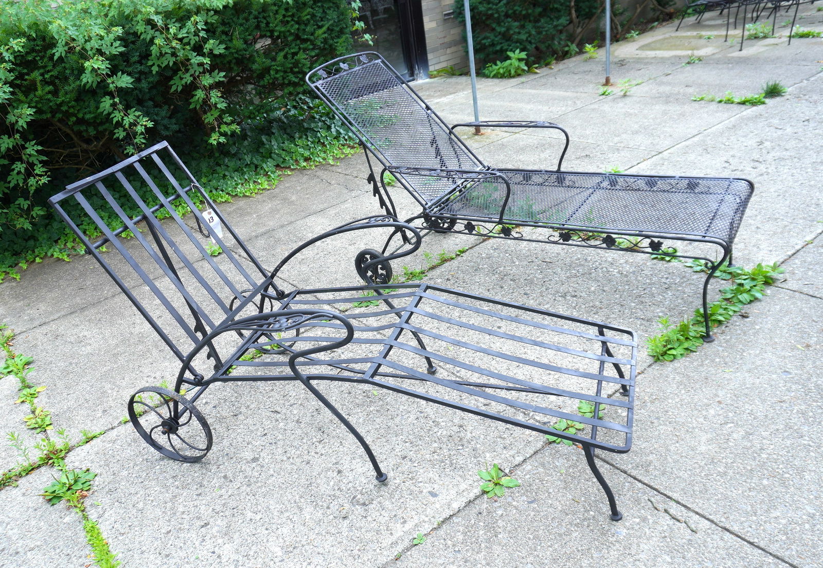 Two wrought iron lounge chairs with adjustable backs and iron wheel, mid to late 20th century. Both (1 of 5)