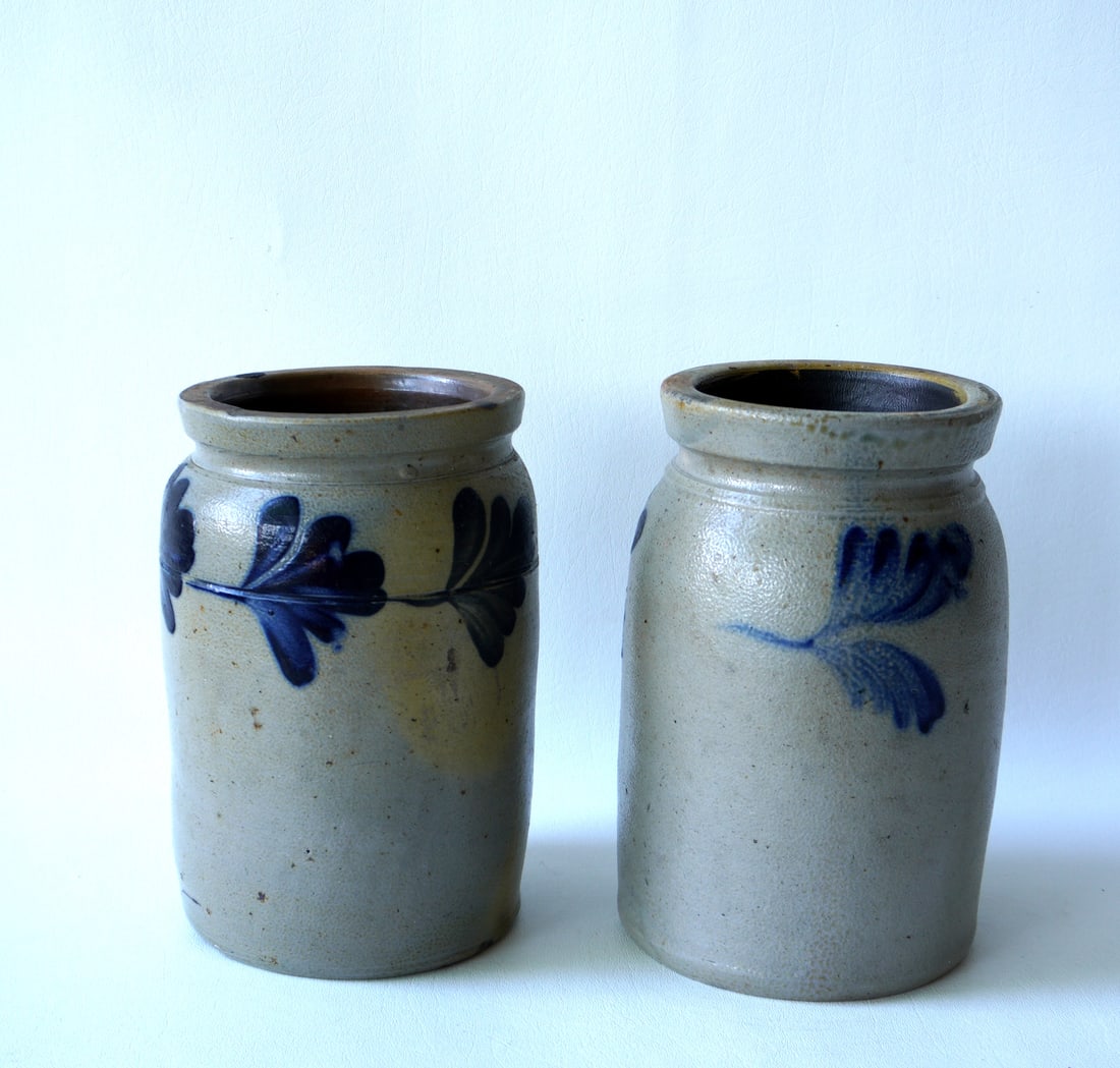 Two stoneware pantry jars decorated with cobalt blue leaves around the bodies, 19th century. Both: Two stoneware pantry jars decorated with cobalt blue leaves around the bodies, 19th century. Both in very good condition with no damage. The largest measures 9 1/4"H.