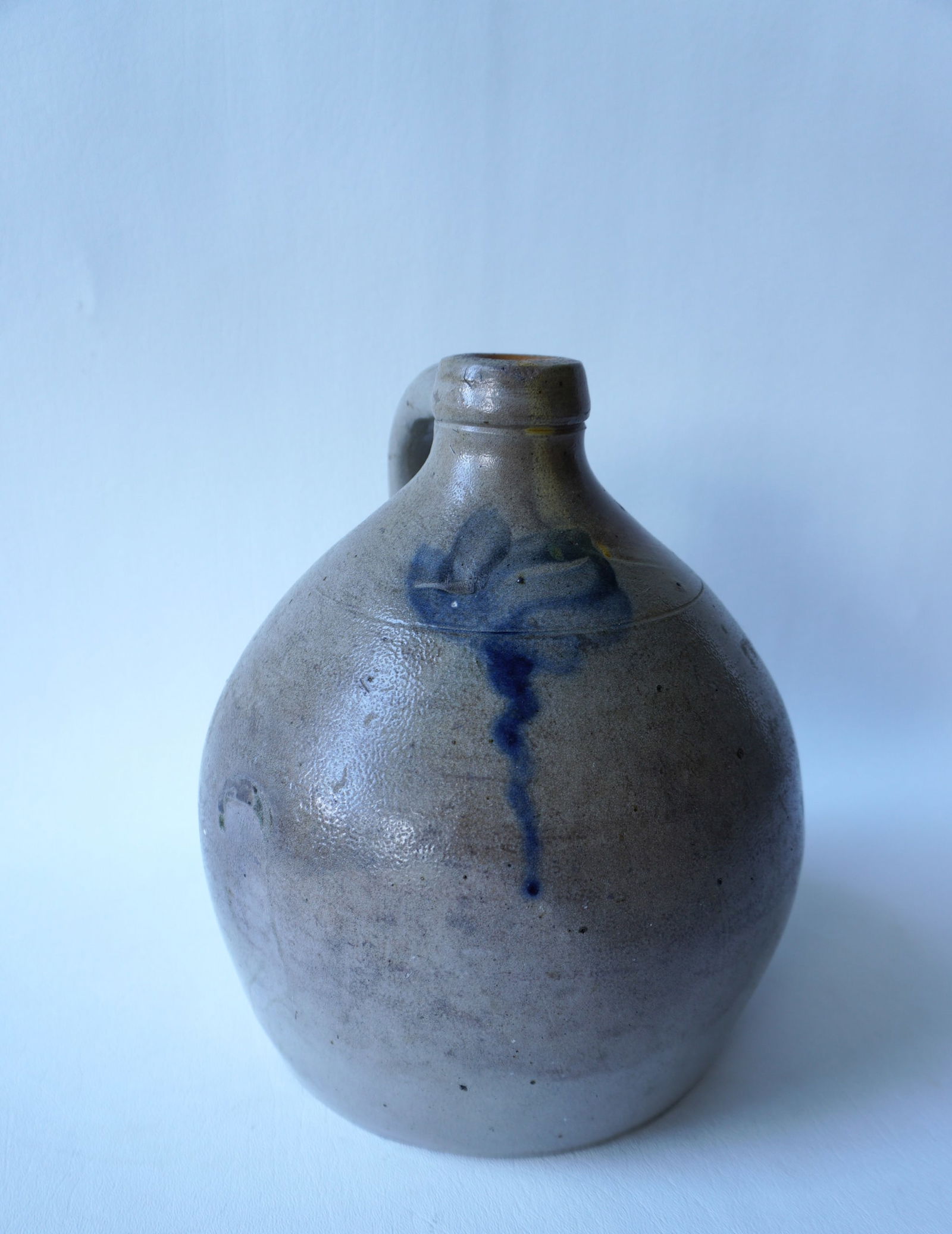 Stoneware jug with slight ovoid shape, 1 gallon size, decorated with a cobalt blue flower, not (1 of 6)