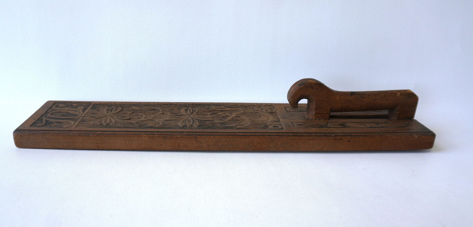 An early Swedish mangle board with styled horse handle and decorated with carved flowers - also (1 of 5)
