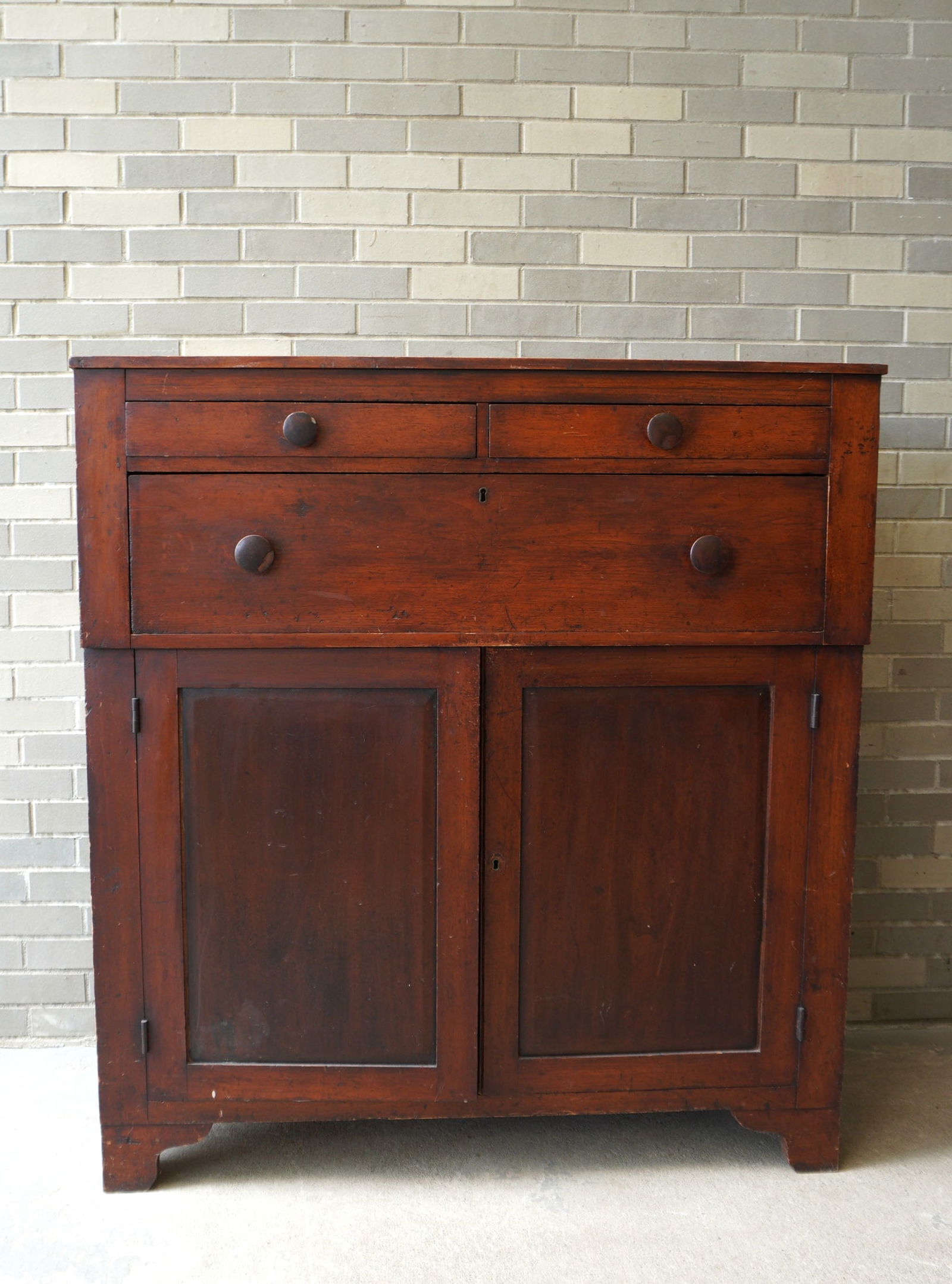Jelly cupboard in natural finish having 2 short drawers over 1 large drawer over 2 doors on a cutout (1 of 10)
