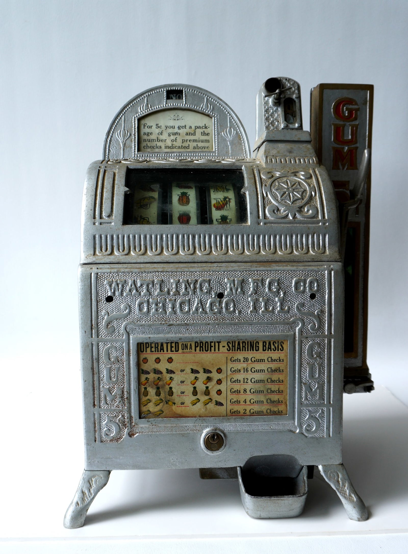 A Watling Mfg. Co. cast iron 3 wheel slot and gum vending machine, 5 cent table model. Early 20th: A Watling Mfg. Co. cast iron 3 wheel slot and gum vending machine, 5 cent table model. Early 20th century. Appears complete but some newer silver paint has been applied to the embossed cast iron frame