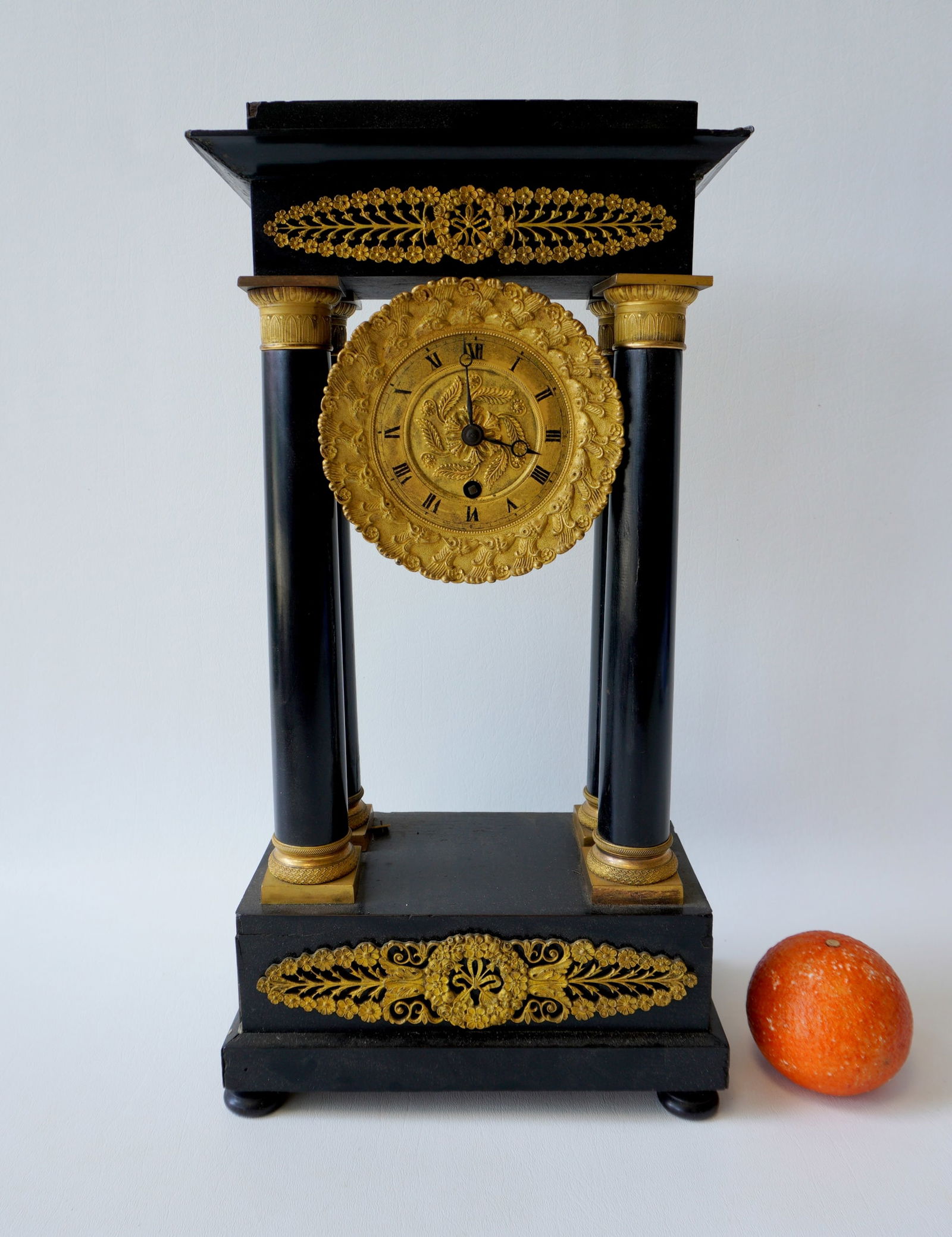 French Empire mantle clock having 4 columns, brass ormolu, with fancy pendulum with dolphins above (1 of 9)