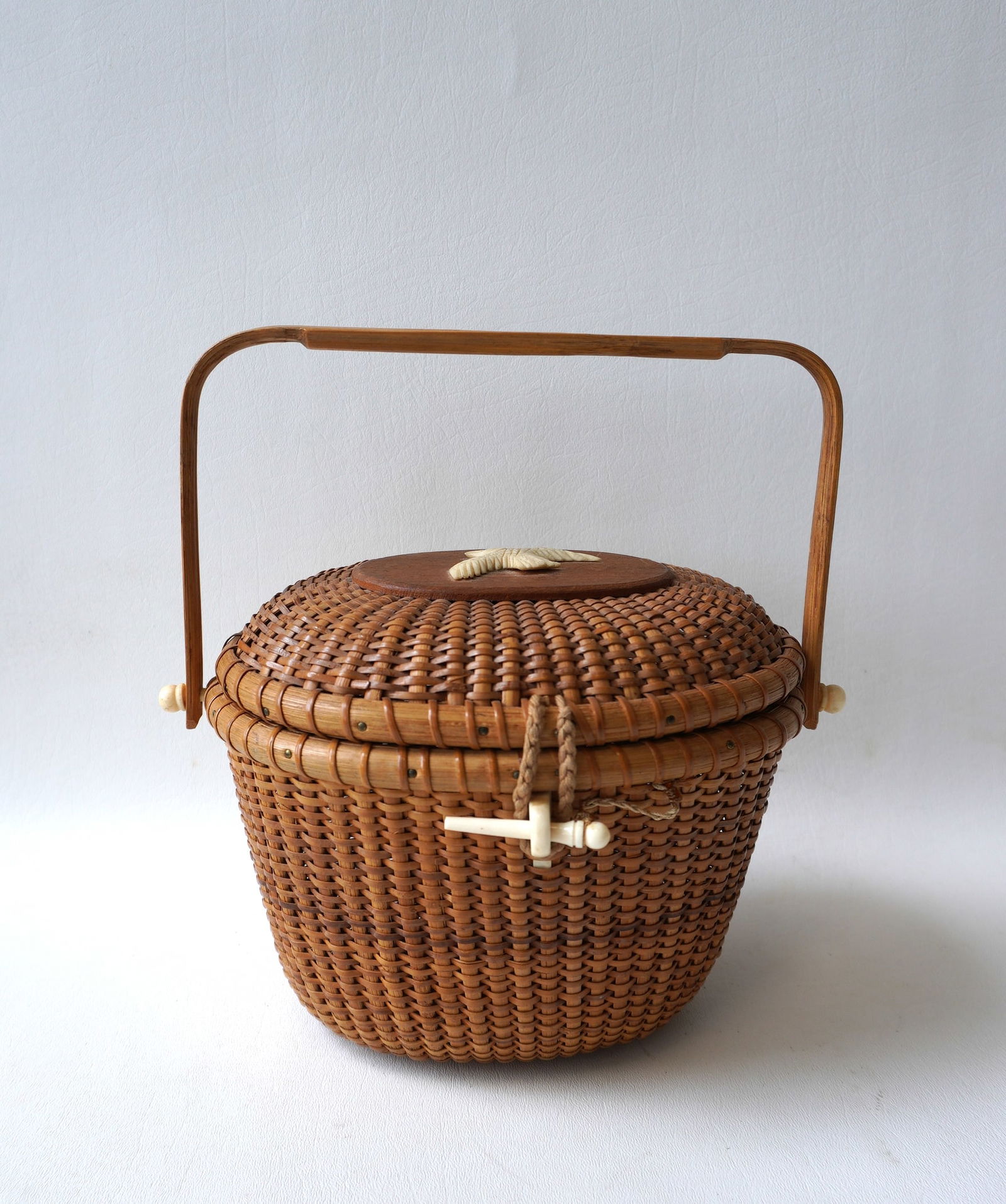 A Nantucket style friendship basket, not signed, having a hand carved eagle faux-ivory ornament (1 of 7)