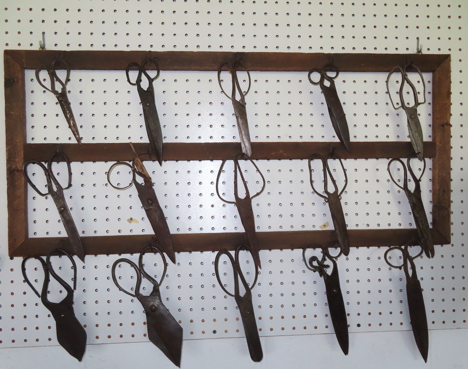 A grouping of 15 hand wrought scissors, most early 19th century and in good condition, mounted on (1 of 9)