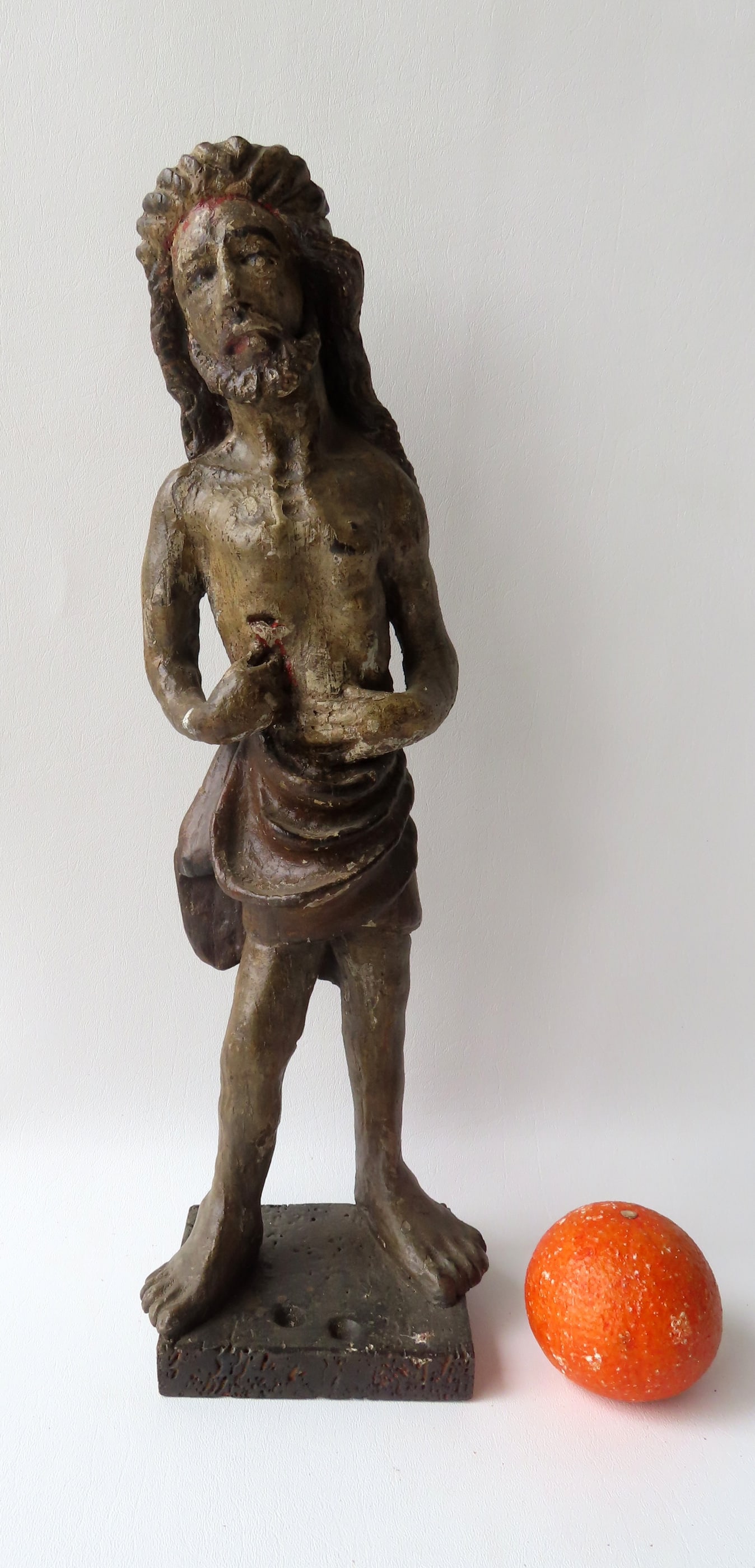 A large carved wooden Spanish Colonial Santos figure depicting Jesus pointing to a wound in his ribs (1 of 6)