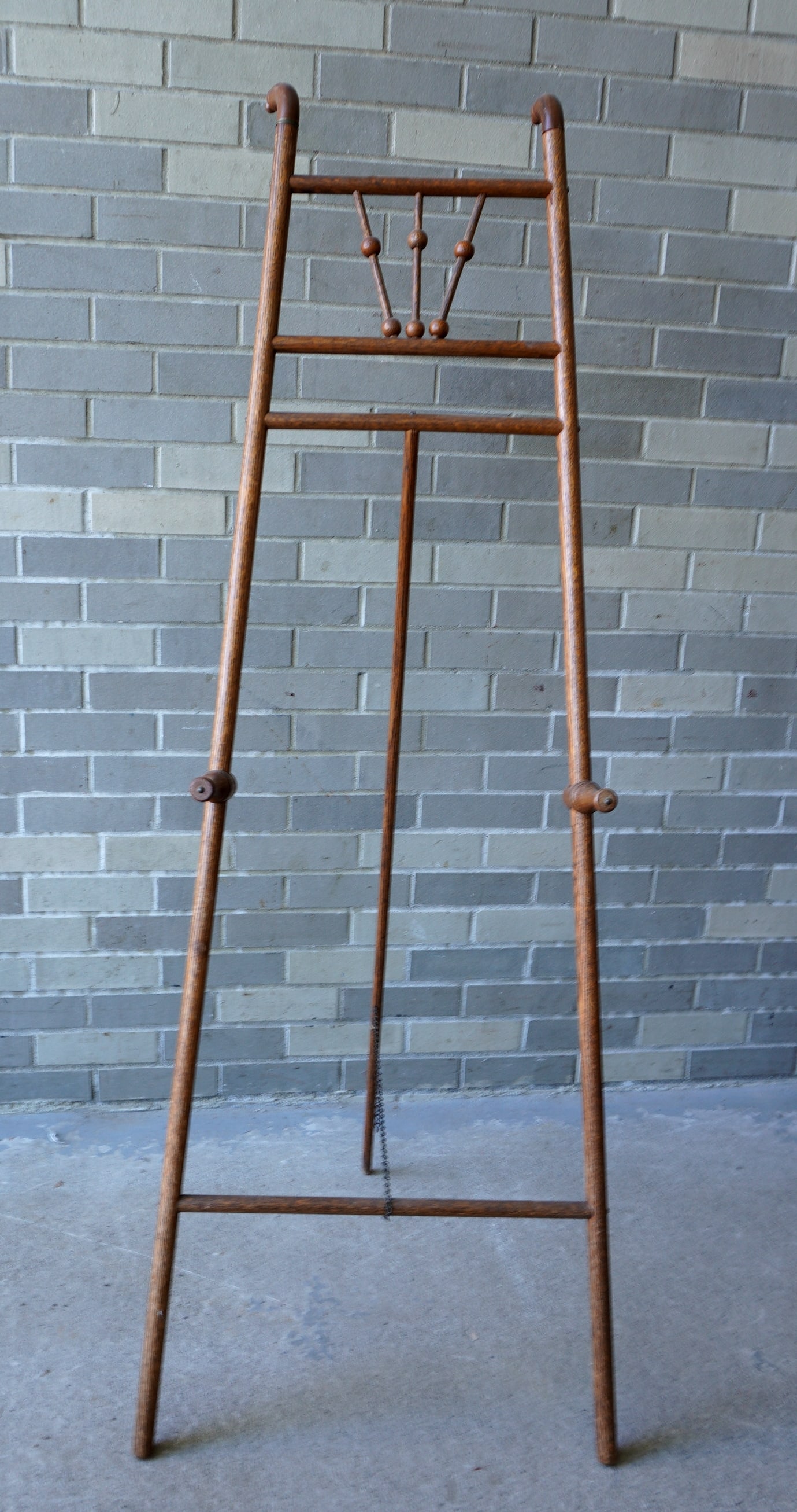 A good stick and ball oak easel,  early 20th century. Measures 23"w x 58 3/4"H. (1 of 3)