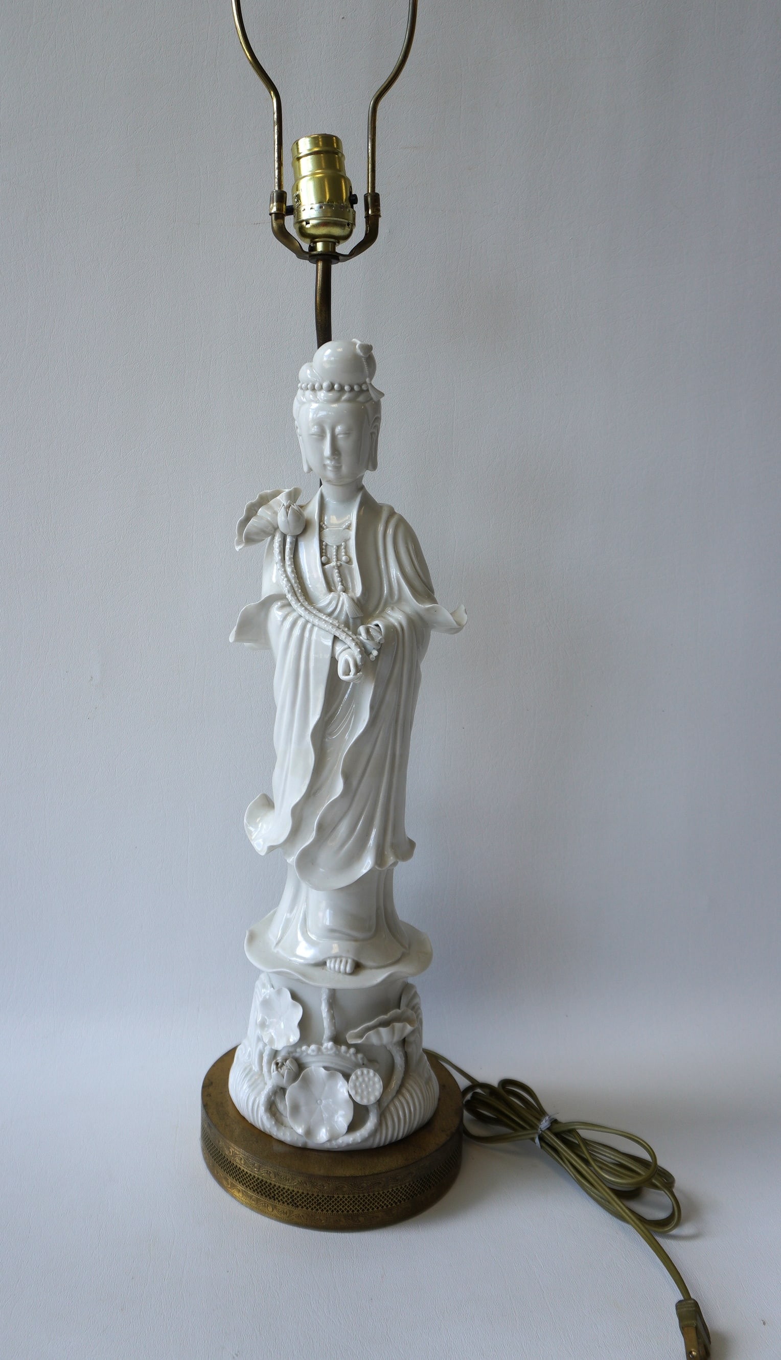 An oriental white porcelain table lamp in the form of a standing oriental lady, unsure of age but (1 of 5)