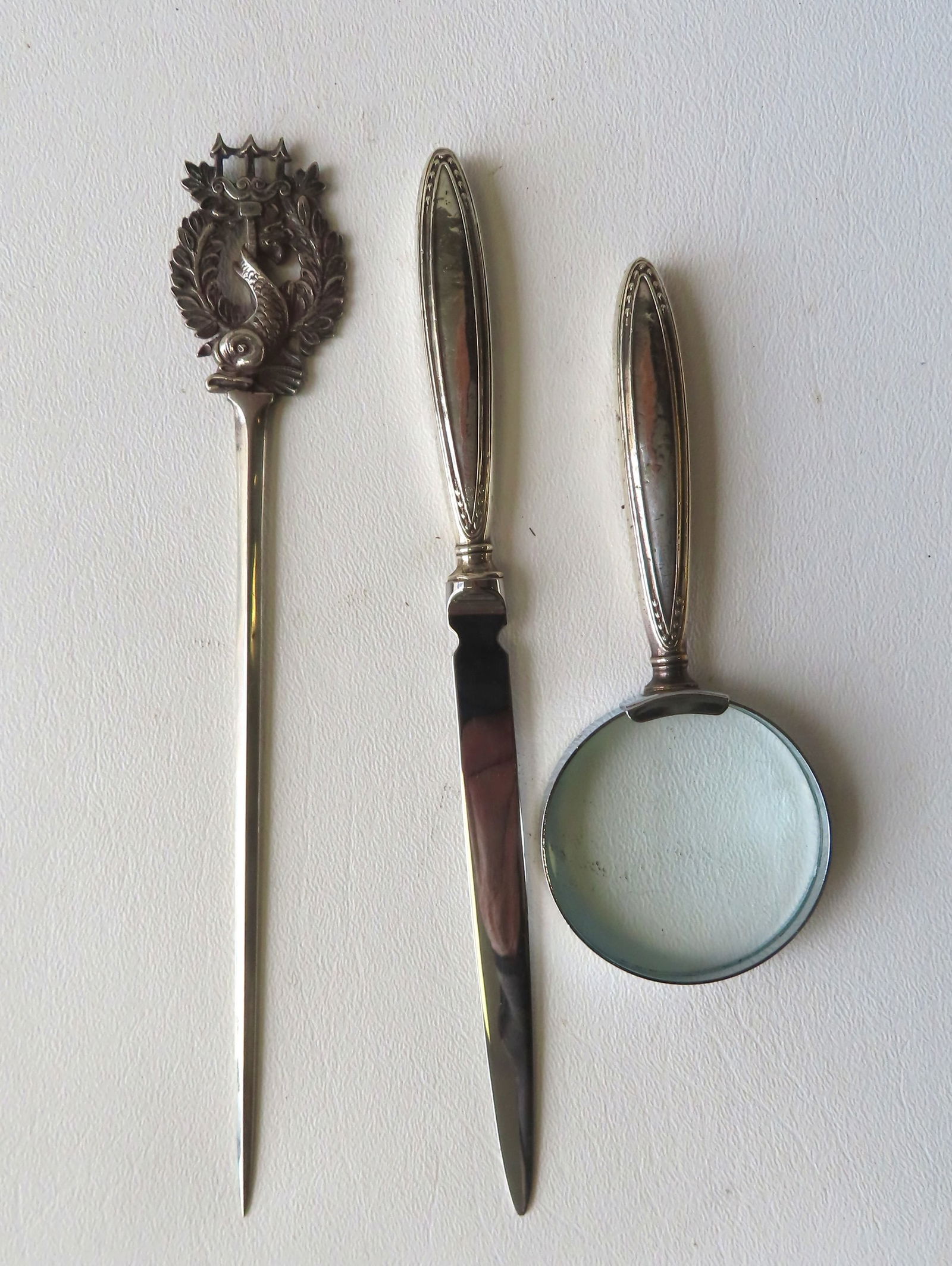 A signed Tiffany & Co. sterling silver envelope opener having a finial depicting a dolphin within (1 of 3)