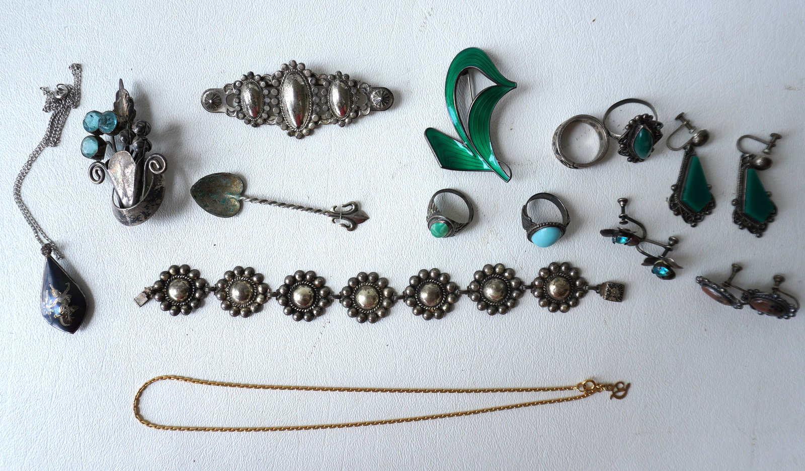 Twelve piece of sterling jewelry including American and Mexican Sterling, some Native American - the: Twelve piece of sterling jewelry including American and Mexican Sterling, some Native American - the brooch of a vase with flowers decorated with 3 rhinestones and one rhinestone with chip, else all a