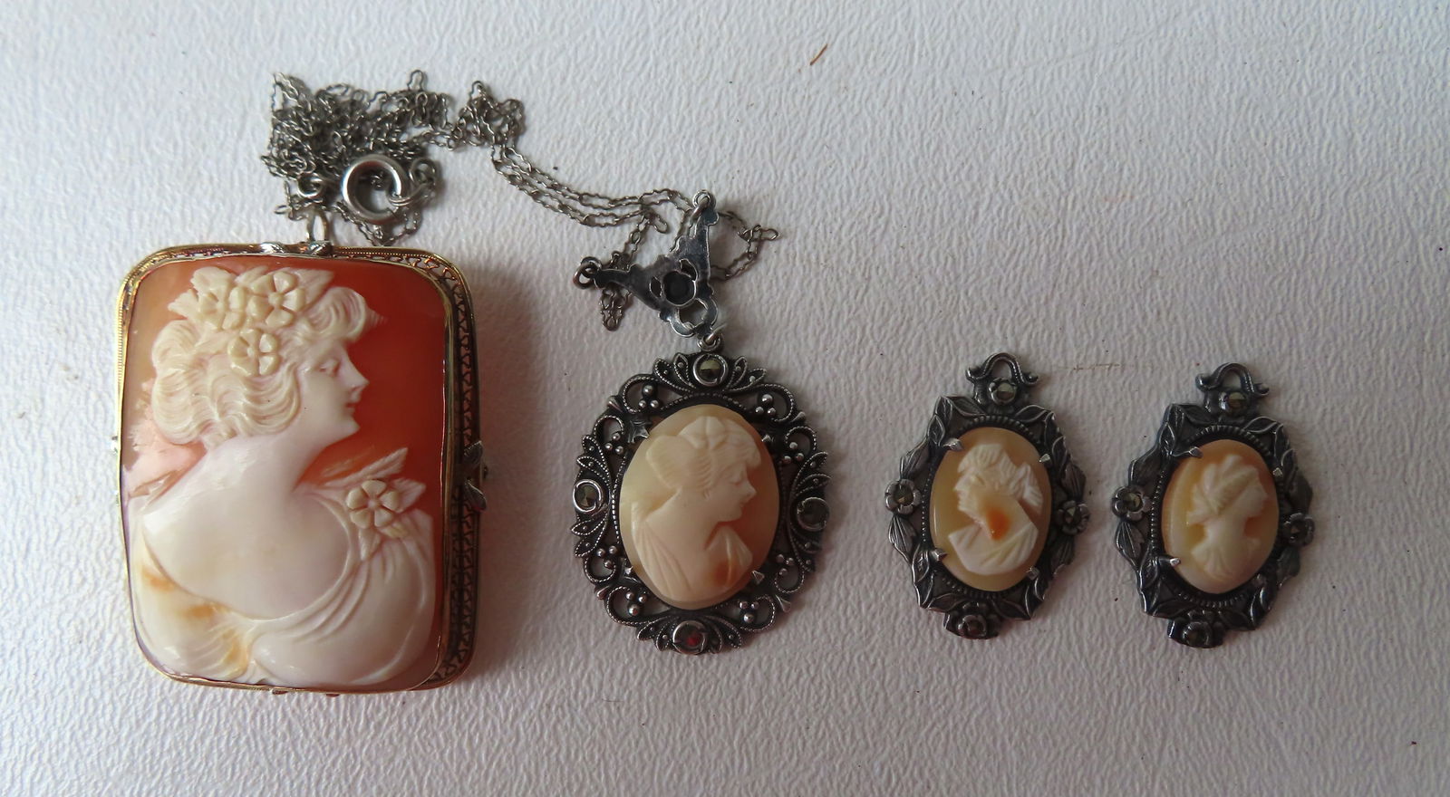 Grouping of 4 vintage cameos, the 3 smaller cameos are housed in sterling silver frames with (1 of 11)