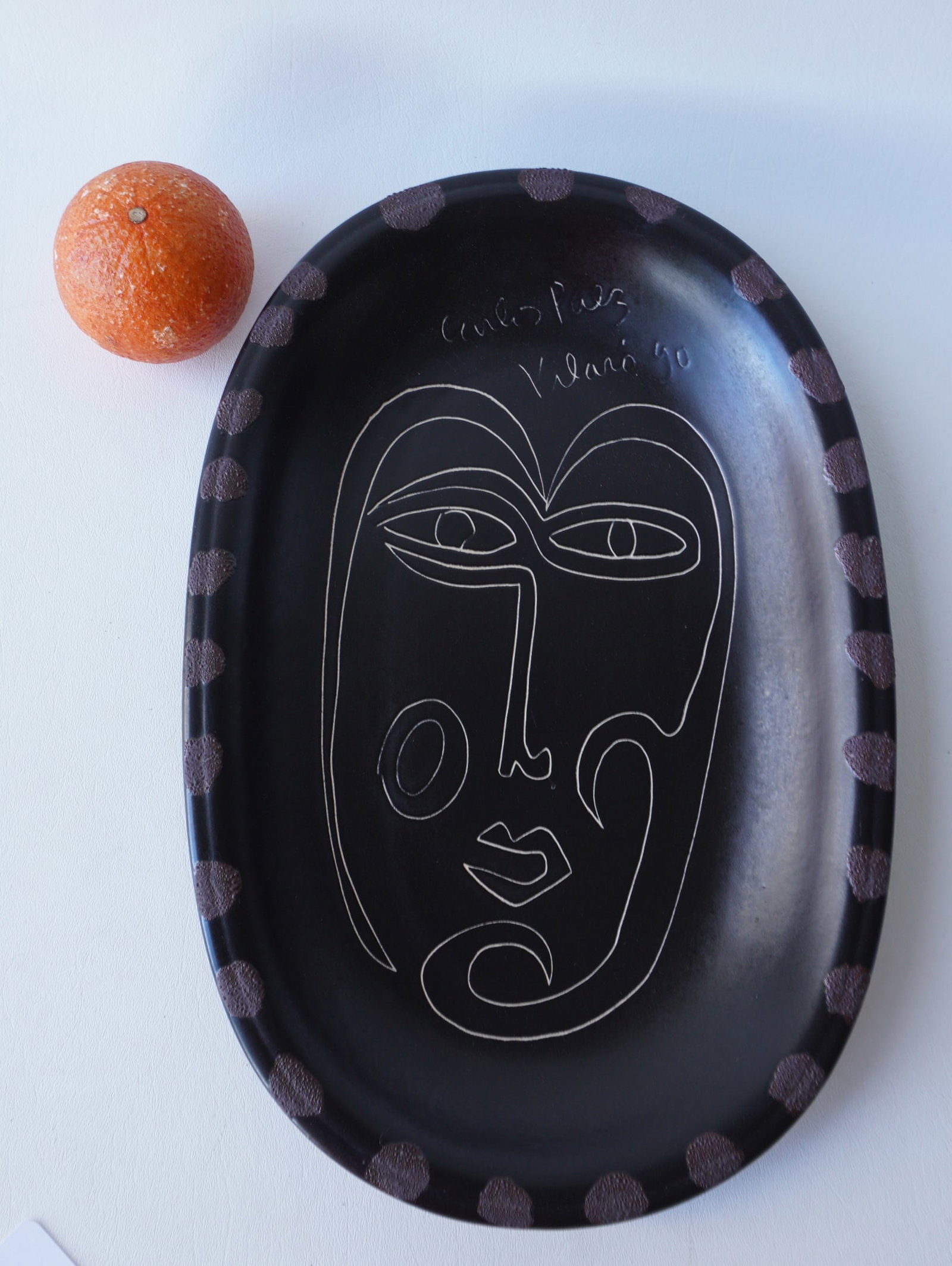 Carlos Paez Vilaro (Uruguay 1923-2014). A ceramic bowl with incised modernistic face decoration on: Carlos Paez Vilaro (Uruguay 1923-2014). A ceramic bowl with incised modernistic face decoration on brown ground. Very good condition, no damage. Measures 10 1/4"W x 15 3/8"L x 1 1/2"D.