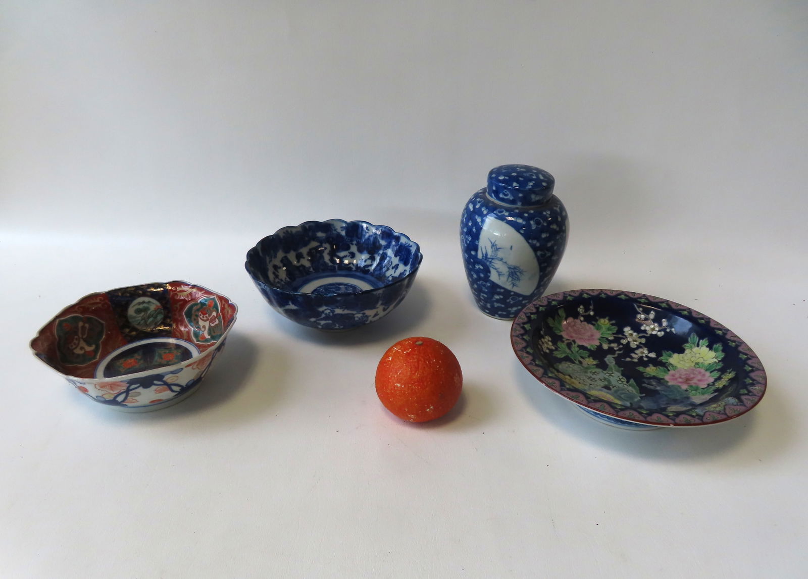 Four oriental porcelain objects including blue and white bowl with scalloped edge and decorated with (1 of 12)
