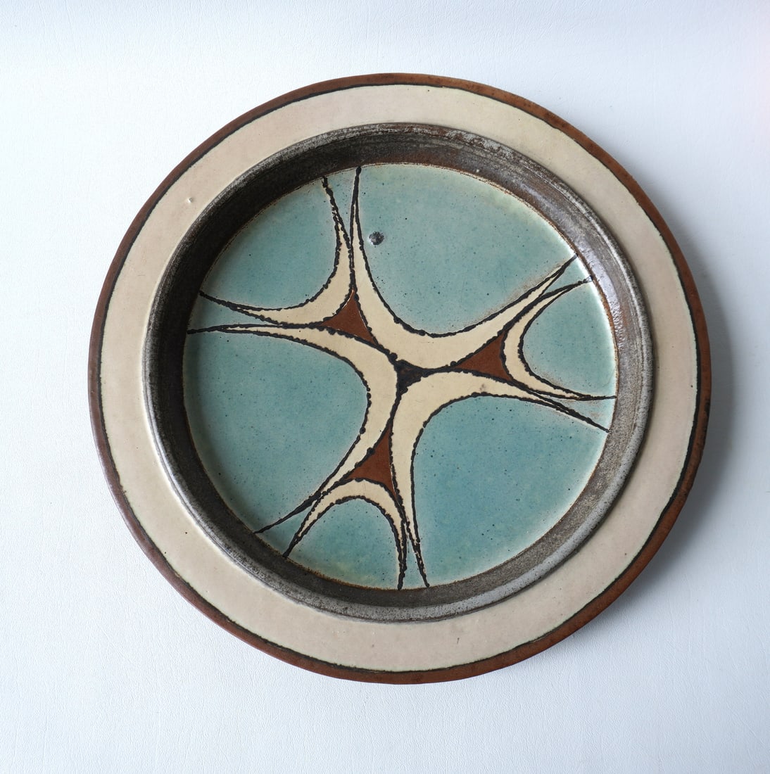 Walter Addison, New York, 1914-1982. A terra cotta hand painted charger decorated in the mid century: Walter Addison, New York, 1914-1982. A terra cotta hand painted charger decorated in the mid century modern style, circa 1950, signed Addison - very good condition - measures 14 3/4" diameter x 2"H. P