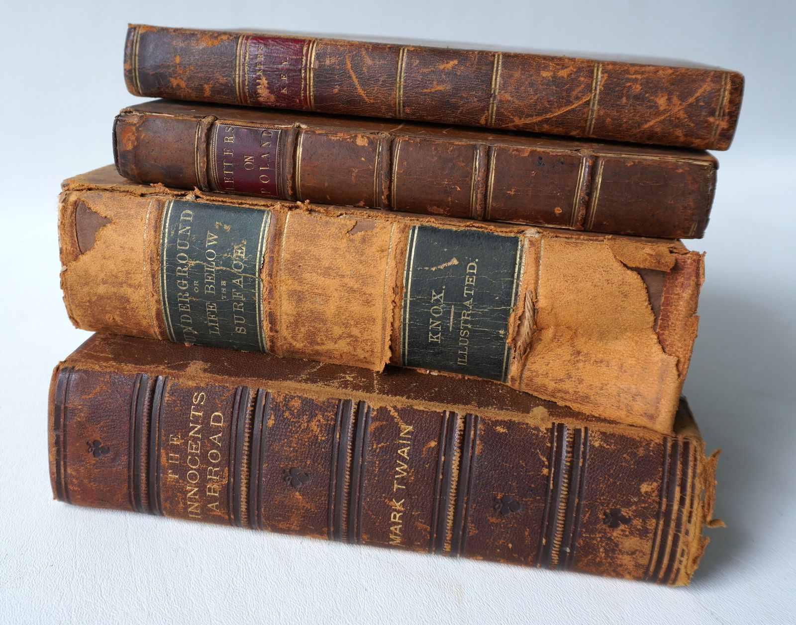 Grouping of 4 early leather bound books including: "The Innocents Abroad or The New Pilgrims' (1 of 6)