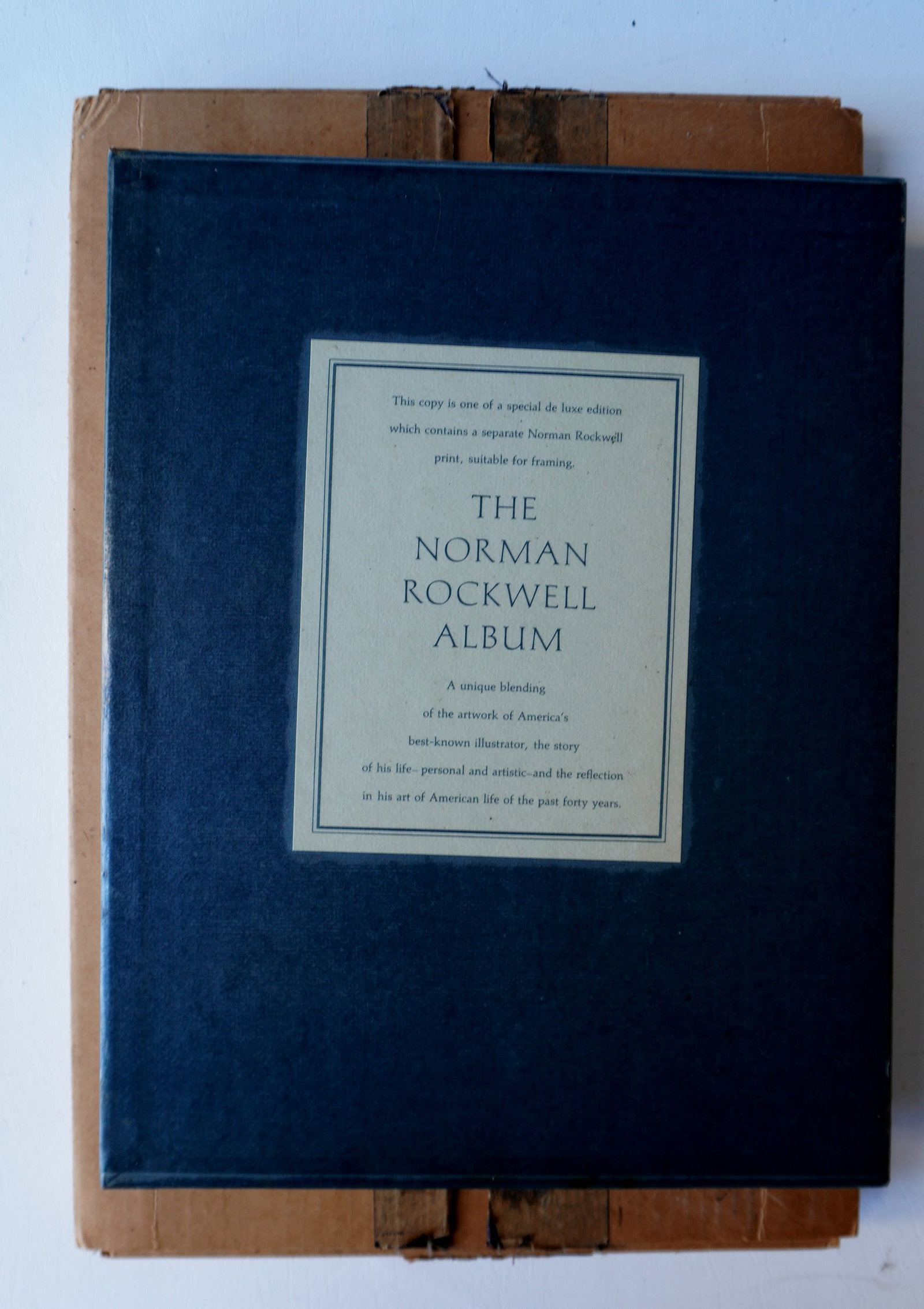 Autographed Rockwell book "The Norman Rockwell Album" in original slipcase. Inscribed on first title: Autographed Rockwell book "The Norman Rockwell Album" in original slipcase. Inscribed on first title page in blue pen "Love to those wonderful grandparents Janet and Arthur from grand pop - Norman" (J
