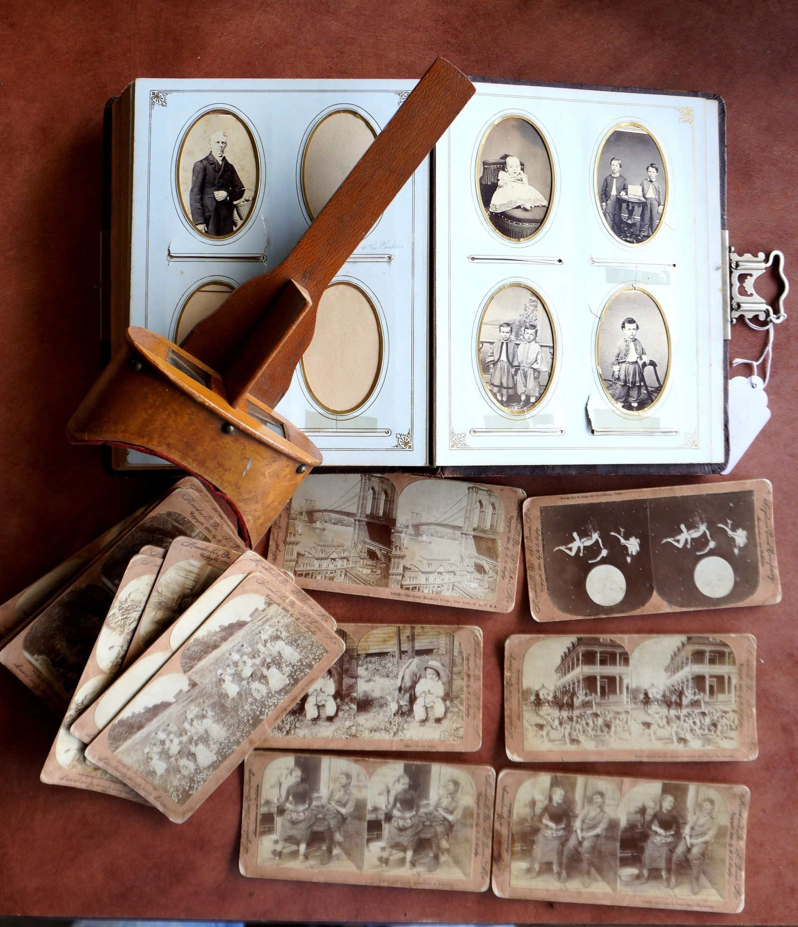 Grouping of old photos including: Cabinet card album containing 9 cabinet card family photos and 13 (1 of 16)