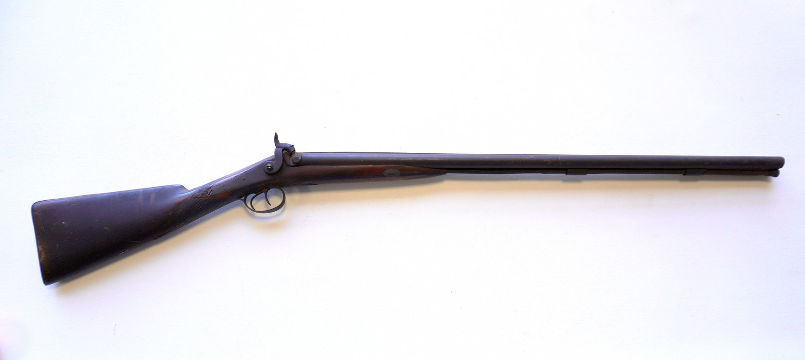 Double barrel percussion shotgun, partially checkered walnut stock. Working action, overall fair to: Double barrel percussion shotgun, partially checkered walnut stock. Working action, overall fair to good condition. Barrel 30 1/2"L and overall 46 1/4"L. Provenance: From a local private collector, do
