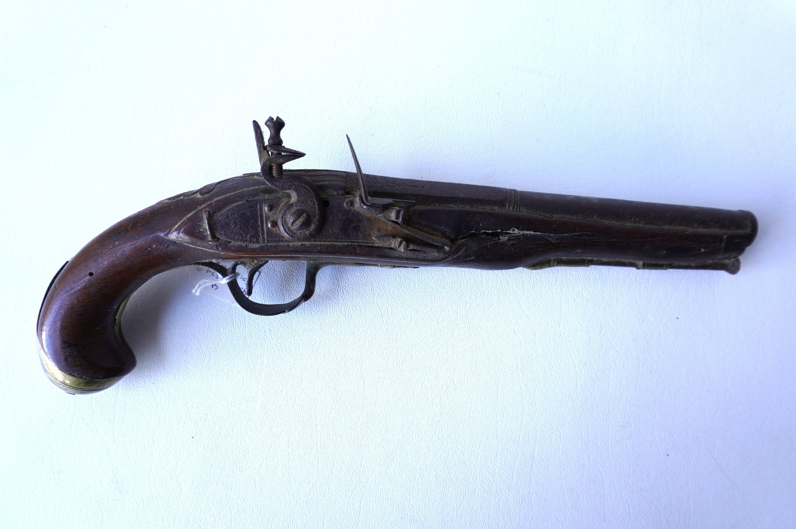 An early flintlock pistol, probably Kentucky, in non-working condition, sold as found. Brass work: An early flintlock pistol, probably Kentucky, in non-working condition, sold as found. Brass work with engravings, and top of barrel also engraved. Some pitting on steel parts, small loss to walnut st