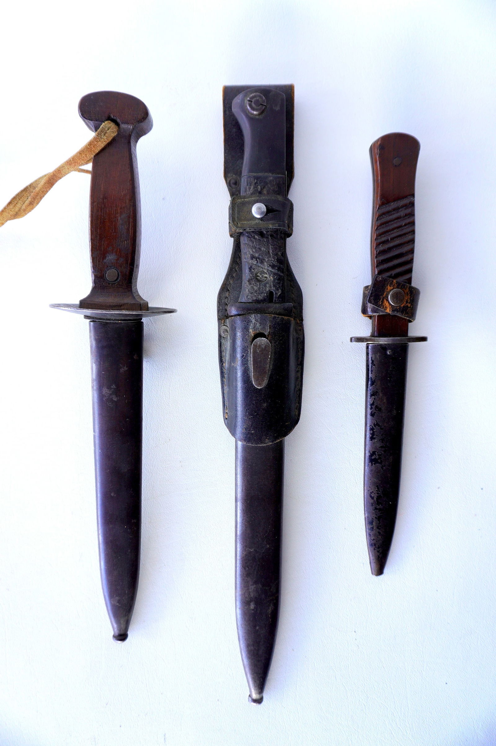 Three military knifes including: Belgian WWI trench dagger signed "Sanderson Bros. & Newbould: Three military knifes including: Belgian WWI trench dagger signed "Sanderson Bros. & Newbould Sheffield", with original steel sheath - good condition - total dagger length 16"; a German WWII bayonet s