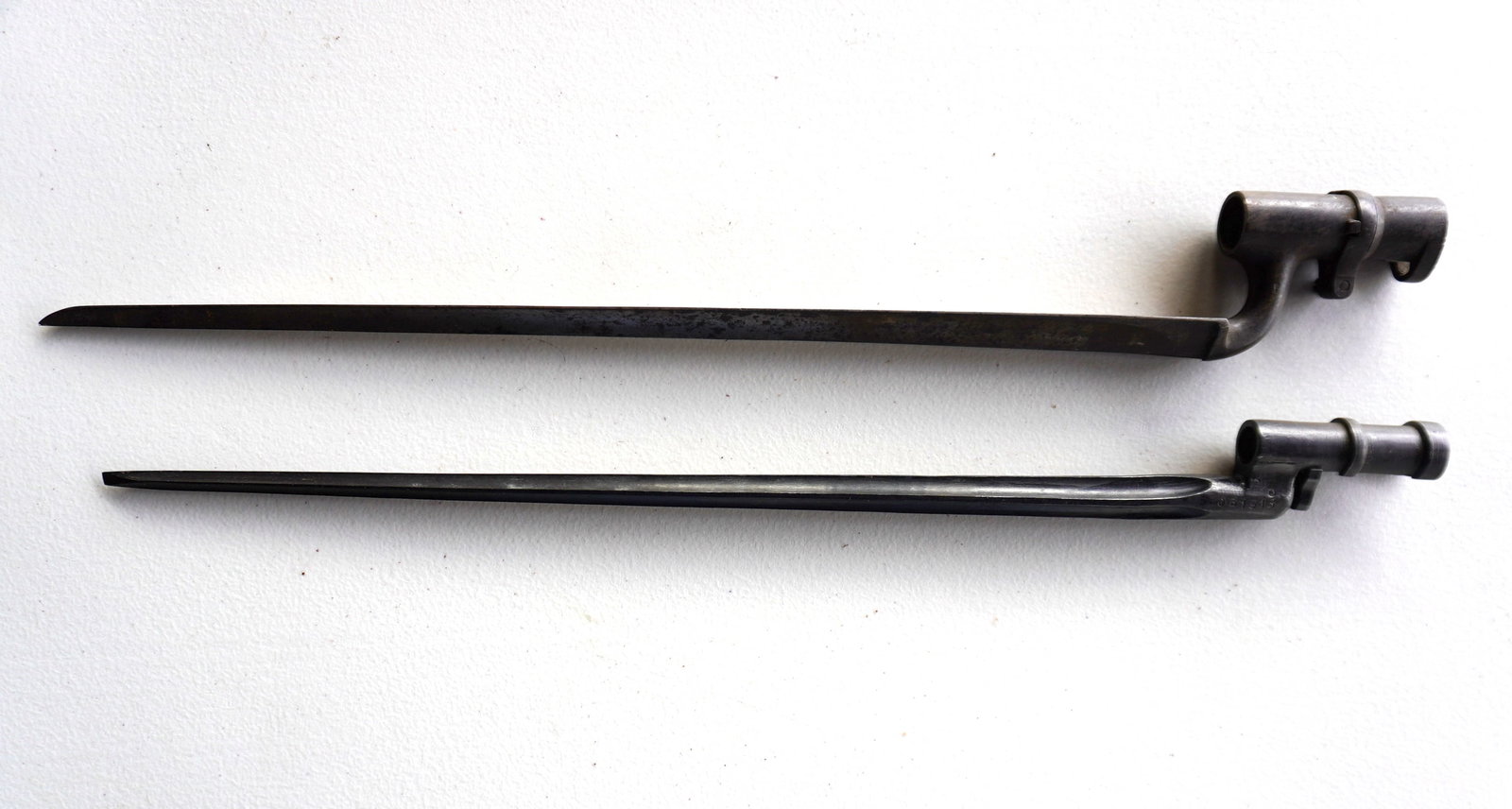 Two early bayonets. The first Civil War or earlier musket socket bayonet with locking ring and blade: Two early bayonets. The first Civil War or earlier musket socket bayonet with locking ring and blade with 3 grooved tapered sides, signed "PJ / crown-mark over H" - some surface rust, but overall good