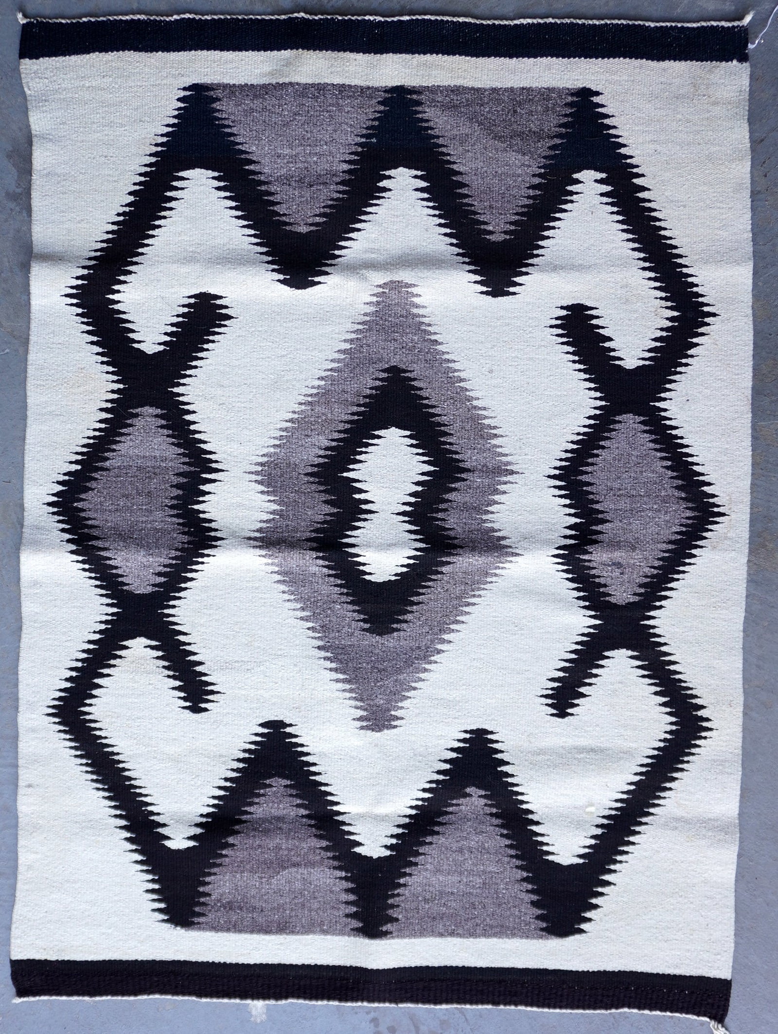 Navajo Eye Dazzler gray tone scatter rug, circa 1900, very good condition. Measures 39" x 53 1/2".: Navajo Eye Dazzler gray tone scatter rug, circa 1900, very good condition. Measures 39" x 53 1/2".