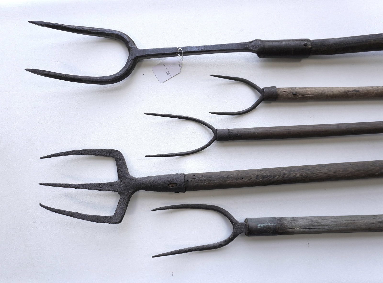 Grouping of 5 blubber forks, 2 hand forged iron. The one with 3 tines, with extensive use wear, and: Grouping of 5 blubber forks, 2 hand forged iron. The one with 3 tines, with extensive use wear, and with impressed signature in handle marked "H. Howd". One missing part of wooden handle, else each in