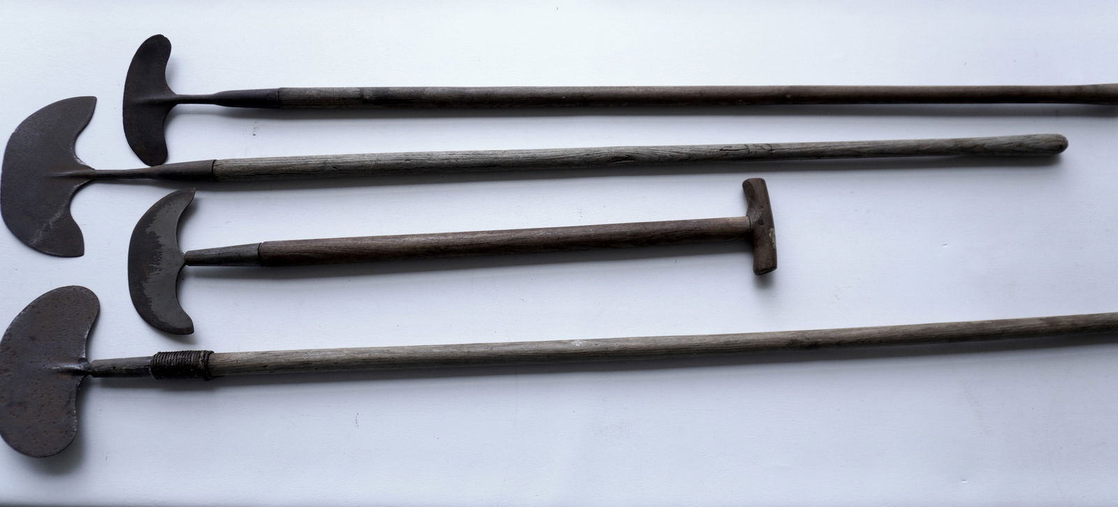 Four long handled iron flensing tools, including a shorter version with T-handle (may be a later: Four long handled iron flensing tools, including a shorter version with T-handle (may be a later replaced handle), early to mid 19th century - includes 3 in wrought iron and 1 hand forged - one of the