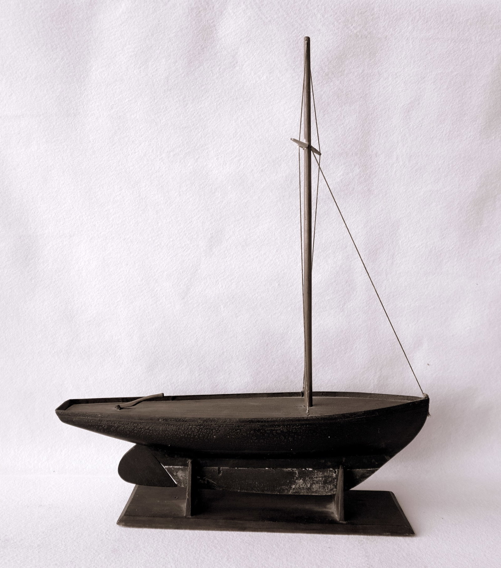 A handmade pond sailboat model in original paint with some crazing, no sales, weighted keel, and in: A handmade pond sailboat model in original paint with some crazing, no sales, weighted keel, and in very good original condition, late 19th to early 20th century. Measures approximately 22 1/2"L x 5"W