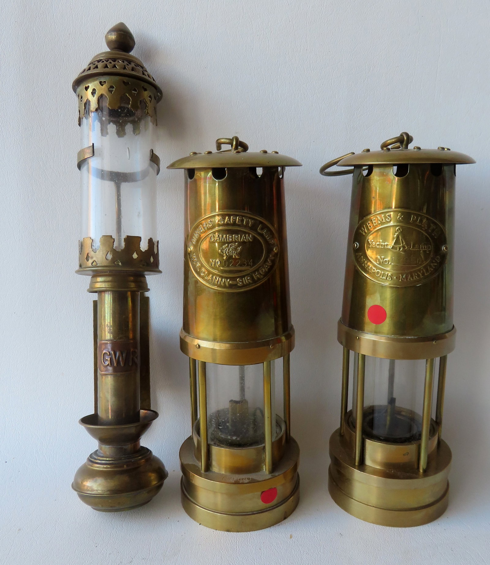 Three brass lanterns including "Miner's Safety Lamp / Cambrian / WR Clanny / Sir H. Davy" with: Three brass lanterns including "Miner's Safety Lamp / Cambrian / WR Clanny / Sir H. Davy" with original burner that screws in from the base - very good condition; similar shaped lamp as previous, sign