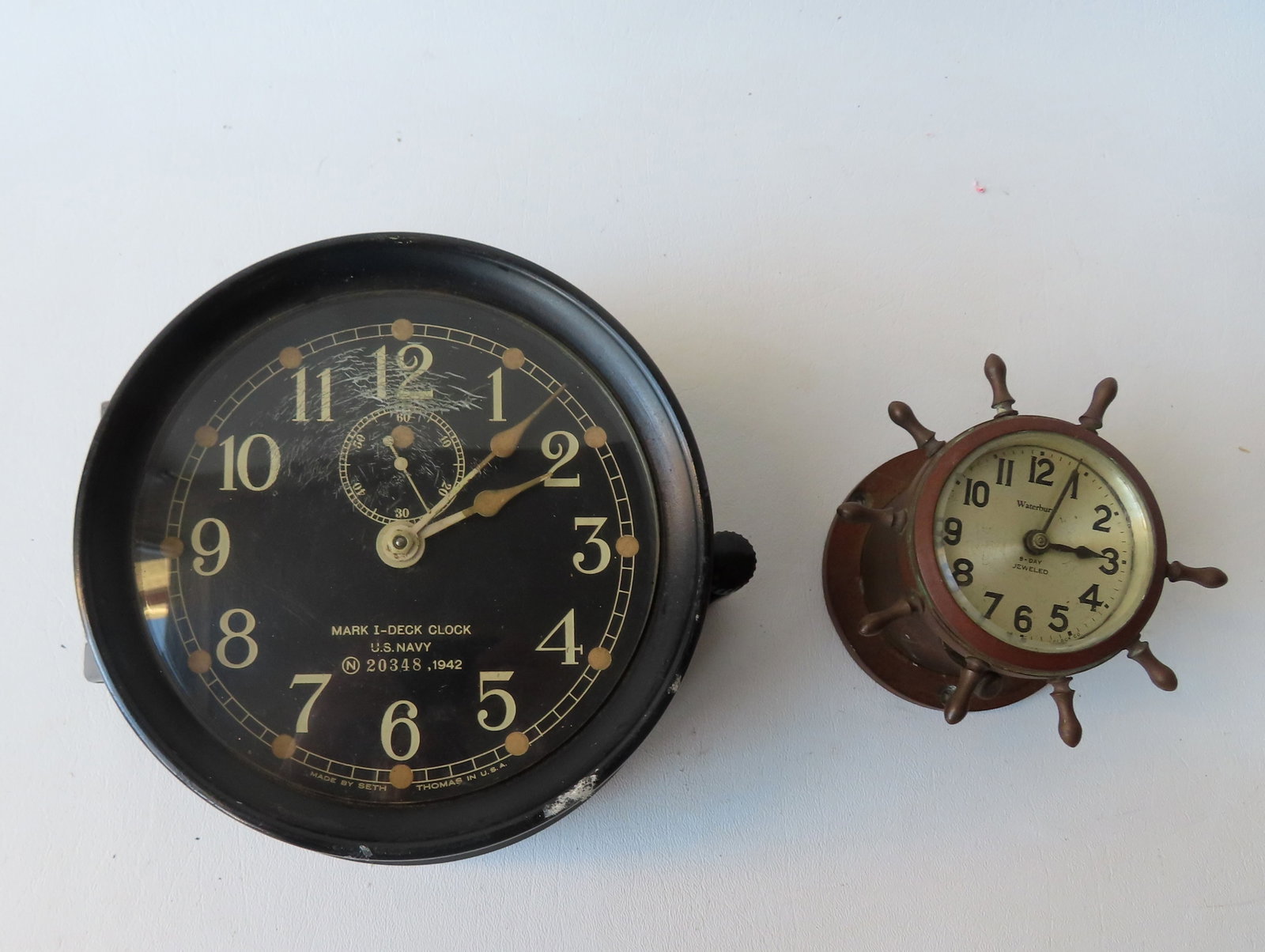 Two ship's clocks. The first a WWII Naval clock marked "Mark I - Deck Clock / U.S. Navy / No. 20348,: Two ship's clocks. The first a WWII Naval clock marked "Mark I - Deck Clock / U.S. Navy / No. 20348, 1942" - wound tight and not working (spring likely broken) - measures 8 1/2"W x 4"H; the second a s