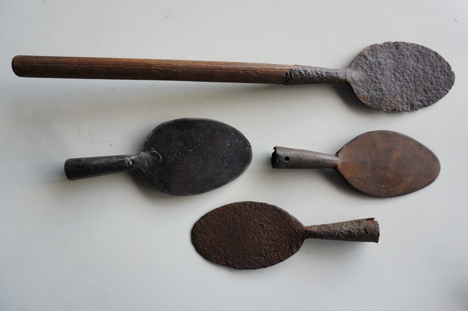 Four hand forged iron blubber spades, 18th/19th century. One with extensive pitting, others in good: Four hand forged iron blubber spades, 18th/19th century, one signed Hilger. Three in good condition and one with extensive pitting. The largest measures 31"L x 5 3/8"W. Provenance: From the estate of 