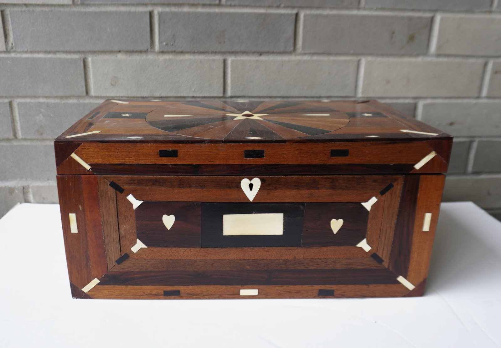 A great sailor made document box with extensive inlays in bone and exotic woods including heart: A great sailor made document box with extensive inlays in bone and exotic woods including heart escutcheon, large star within center of starburst inlays on lid - other inlaid bone decorations' through
