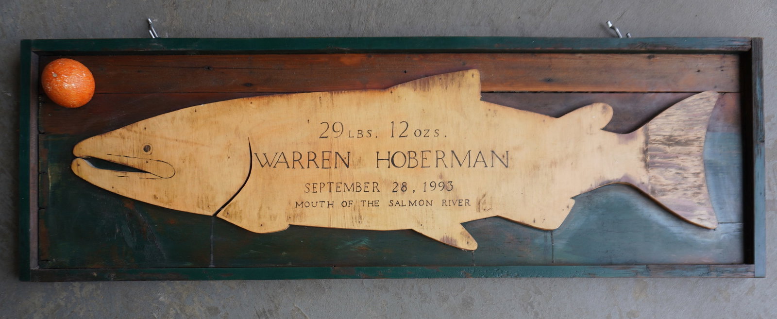 A mounted carved silhouette wooden Salmon to commemorate the catch of the 29 LBS. 12 Oz fish caught: A mounted carved silhouette wooden Salmon to commemorate the catch of the 29 LBS. 12 Oz fish caught by a Warren Hoberman on September 28, 1993 at the "Mouth Of The Salmon River". Measures 48 1/2"L x 1