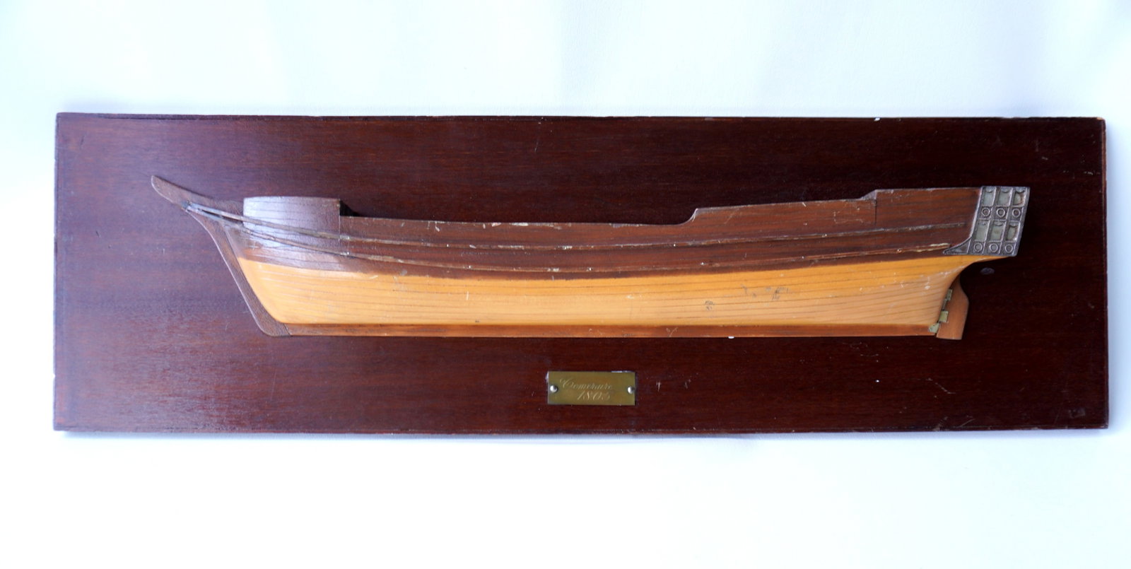 A half hull ship model with brass plaque signed "Temeraire 1805", early to mid 20th century. The HMS: A half hull ship model with brass plaque signed "Temeraire 1805", early to mid 20th century. The HMS Temeraire, launched in 1798, was a 98-gun second-rate ship of the line of the United Kingdom's Roya