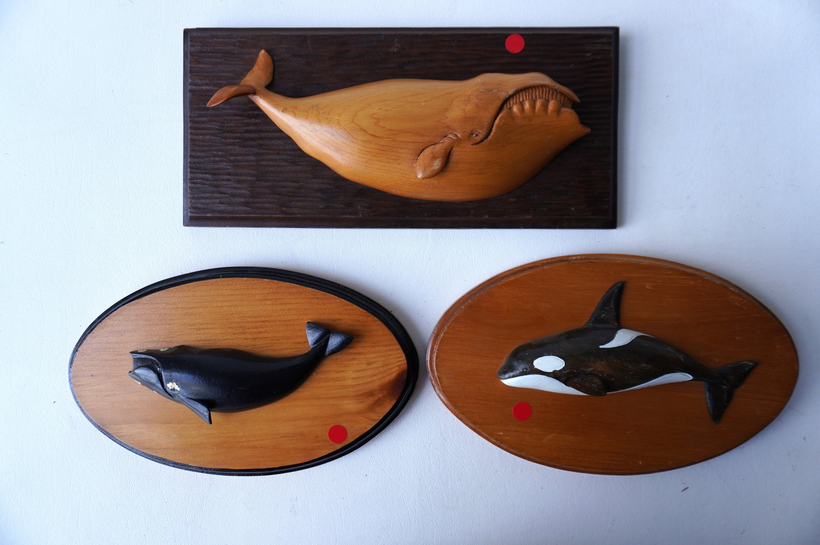 Three small carved wooden whale plaques including: Two matching in original paint signed "Paul: Three small carved wooden whale plaques including: Two matching in original paint signed "Paul McCarthy / Nantucket Brewster" - one titled "Killer Whale #5" - (died 2023, Scituate, Massachusetts - mas