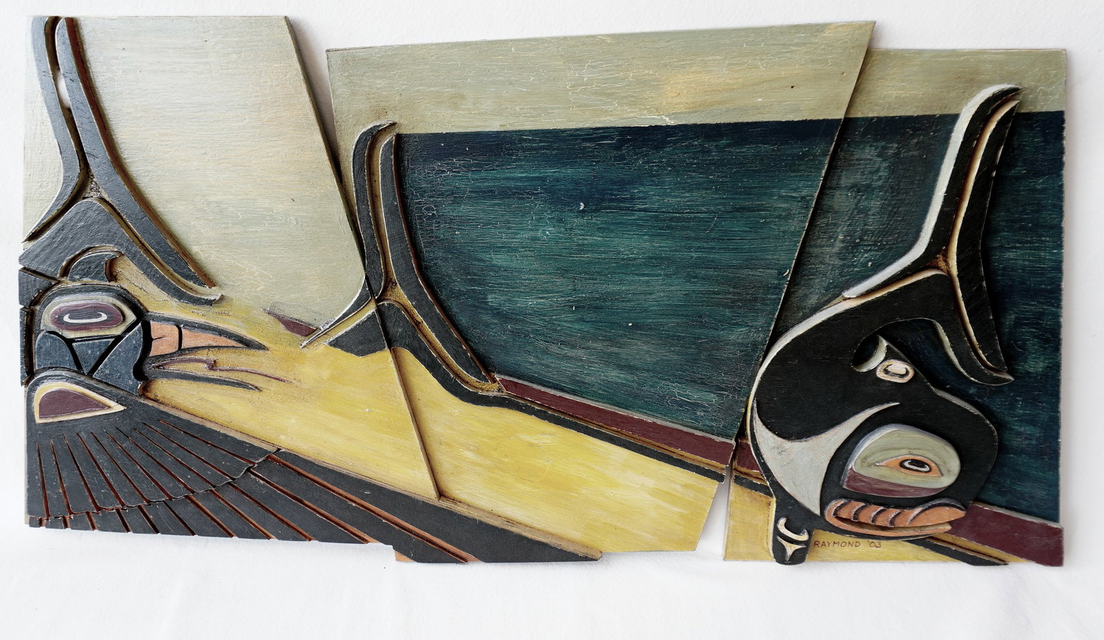 Jeff Raymond custom made Northwest Coast style wooden wall plaque in the form of a stylized seagull: Jeff Raymond custom made Northwest Coast style wooden wall plaque in the form of a stylized seagull and dolphin, in original paint, signed Raymond '03. Note the 3 board construction. Measures 51 1/2"W