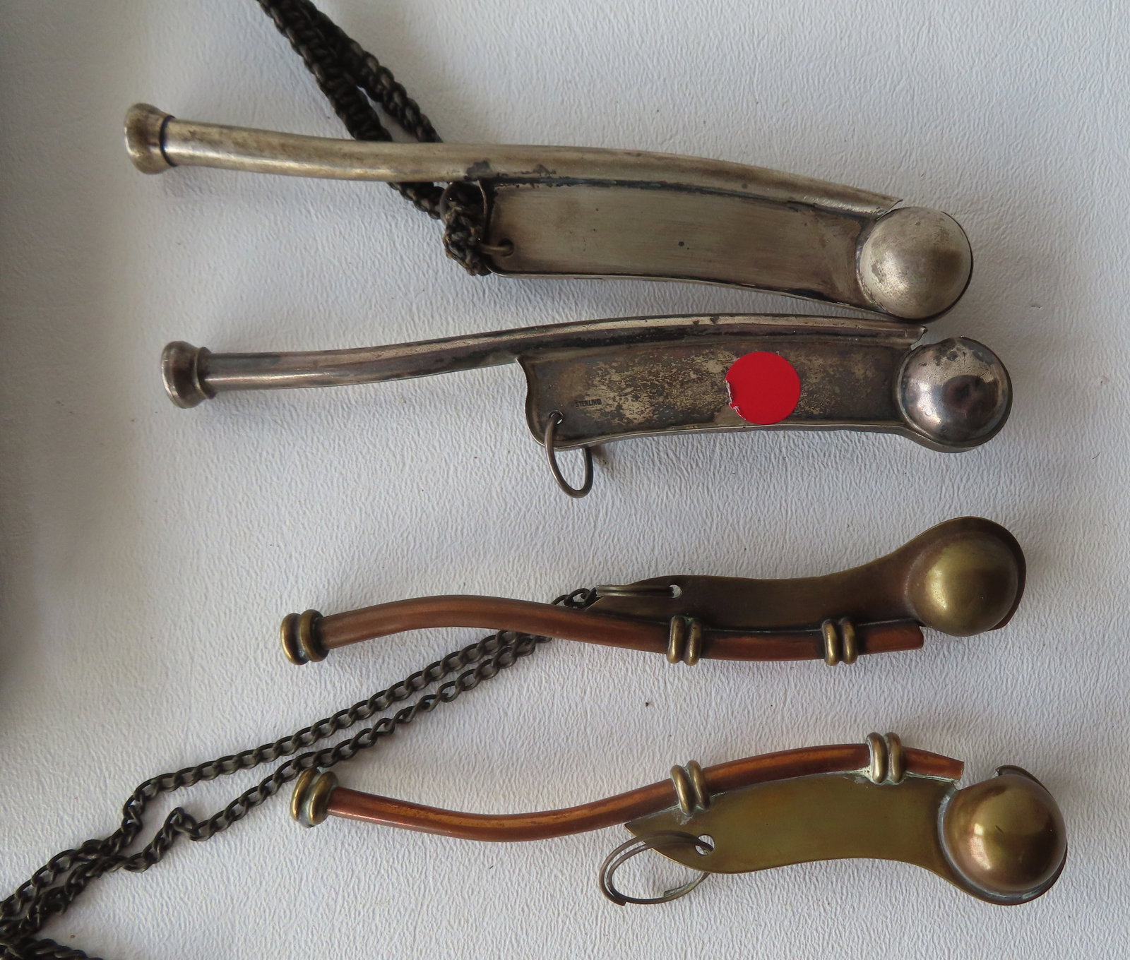 Four bosun's metal whistles including 1 in sterling silver. All in good condition, late 19th to: Four bosun's metal whistles including 1 in sterling silver, 1 in unmarked silver and 2 in brass. All in good condition, late 19th to early 20th century. The largest measures 5 1/2"L. Note the sailor m
