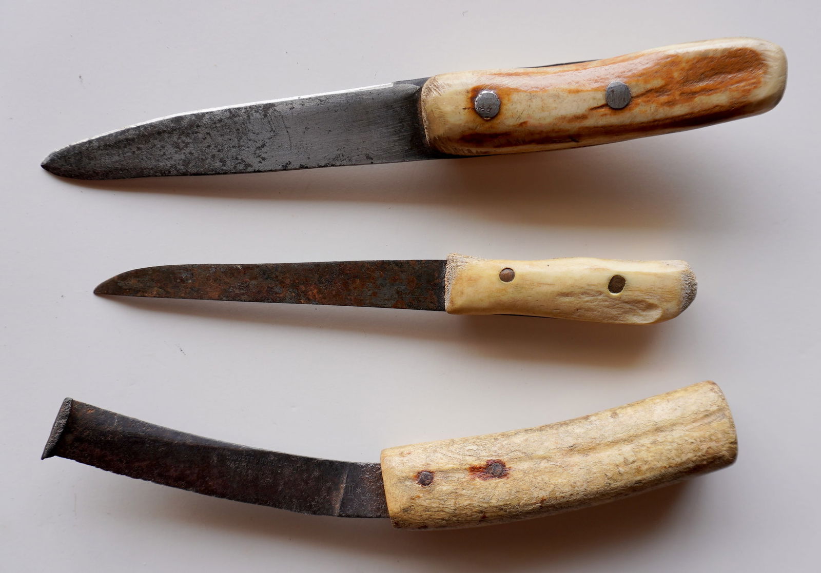 Three hand made knives with animal bone handles, 19th century,: Three hand made knives with animal bone handles, 19th century, including 2 sailor's knives without sheaths, and 1 farrier's hoof knife signed WOSTENHOLM AND SON, WASHINGTON WORKS SCHEFFIELD. All used