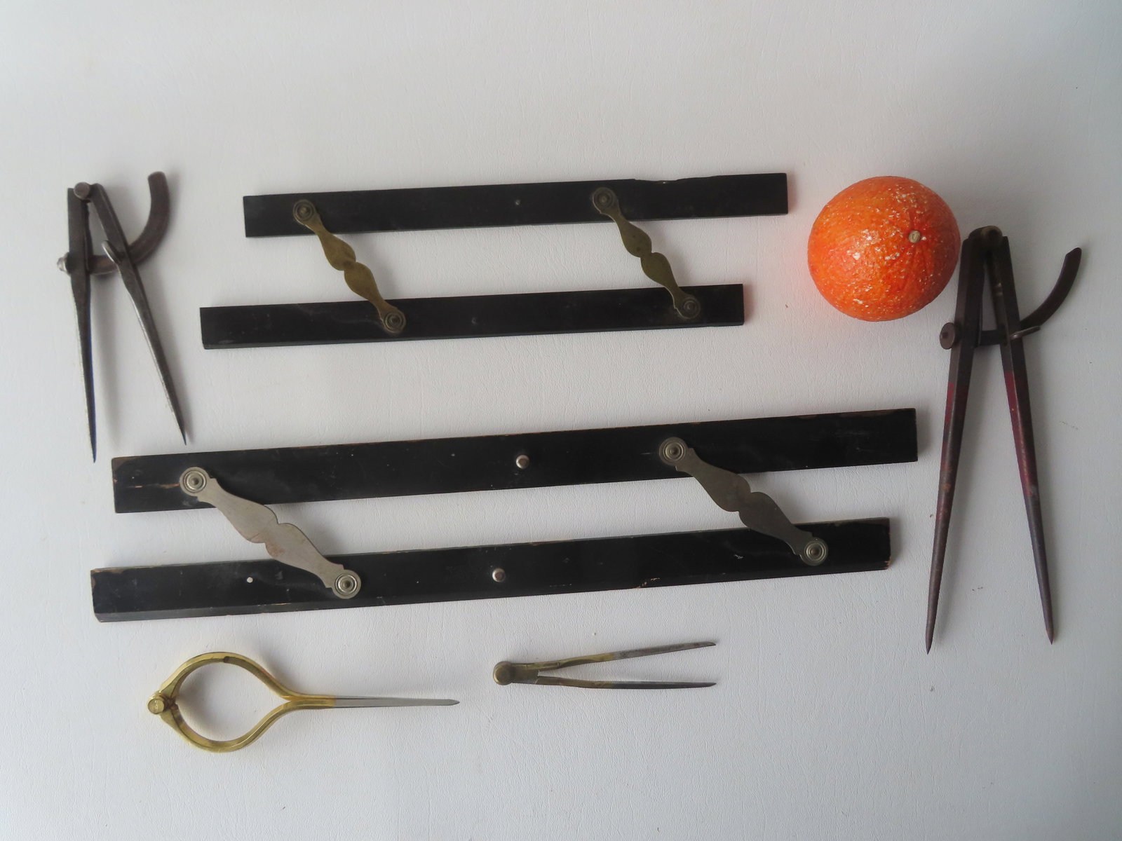 A grouping of 6 nautical measuring tools including: 2 wooden parallel rules - the larger, lacquered: A grouping of 6 nautical measuring tools including: 2 wooden parallel rules - the larger, lacquered finish signed Keuffel & Esser Co. - 18"L - lacquer chips and use wear otherwise good condition and t