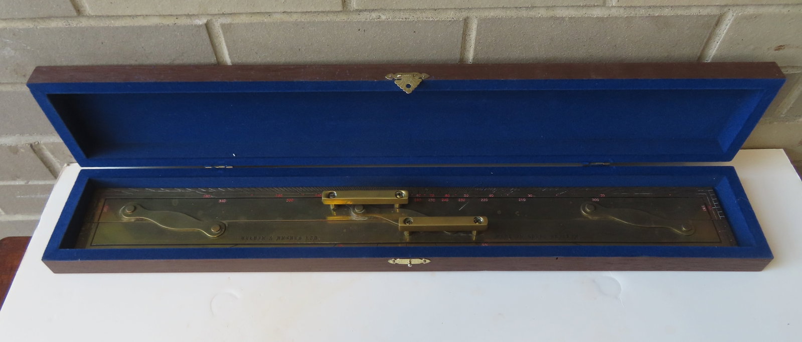 A large contemporary brass parallel rule in original box, marked "Made in Great Britain",circa 2000.: A large contemporary brass parallel rule in original box, marked "Made in Great Britain",circa 2000. Very good condition.The box measures 25"L x 2"H. Provenance: From the estate of Jeff Raymond, Red H